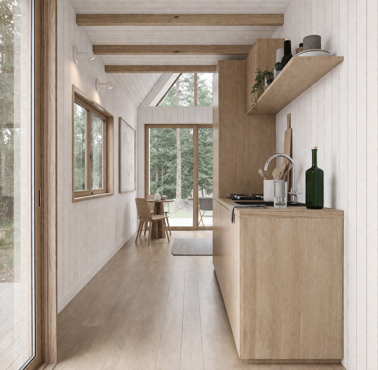 A kitchen and dining area with wood cabinets, walls, and flooring, large windows and sliding glass door showing an outdoor scene of mother nature, a small round high top dining table with two chairs.