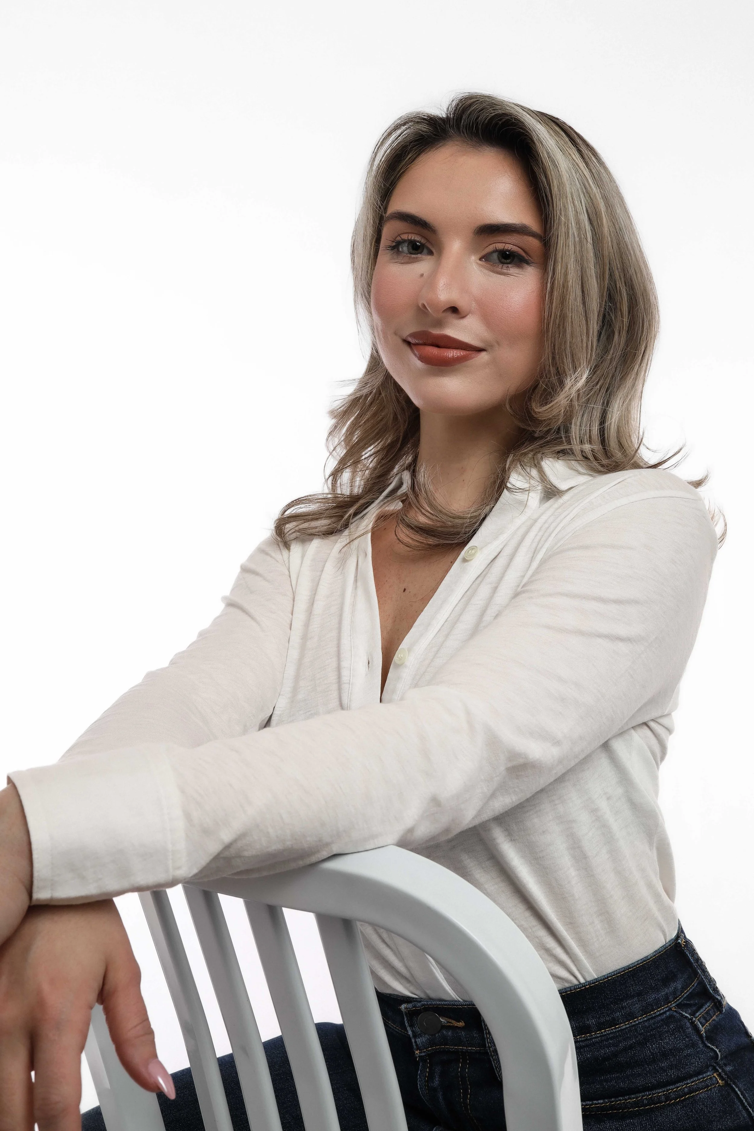 Valerie Headshot - leaning on chair soft smile.jpg