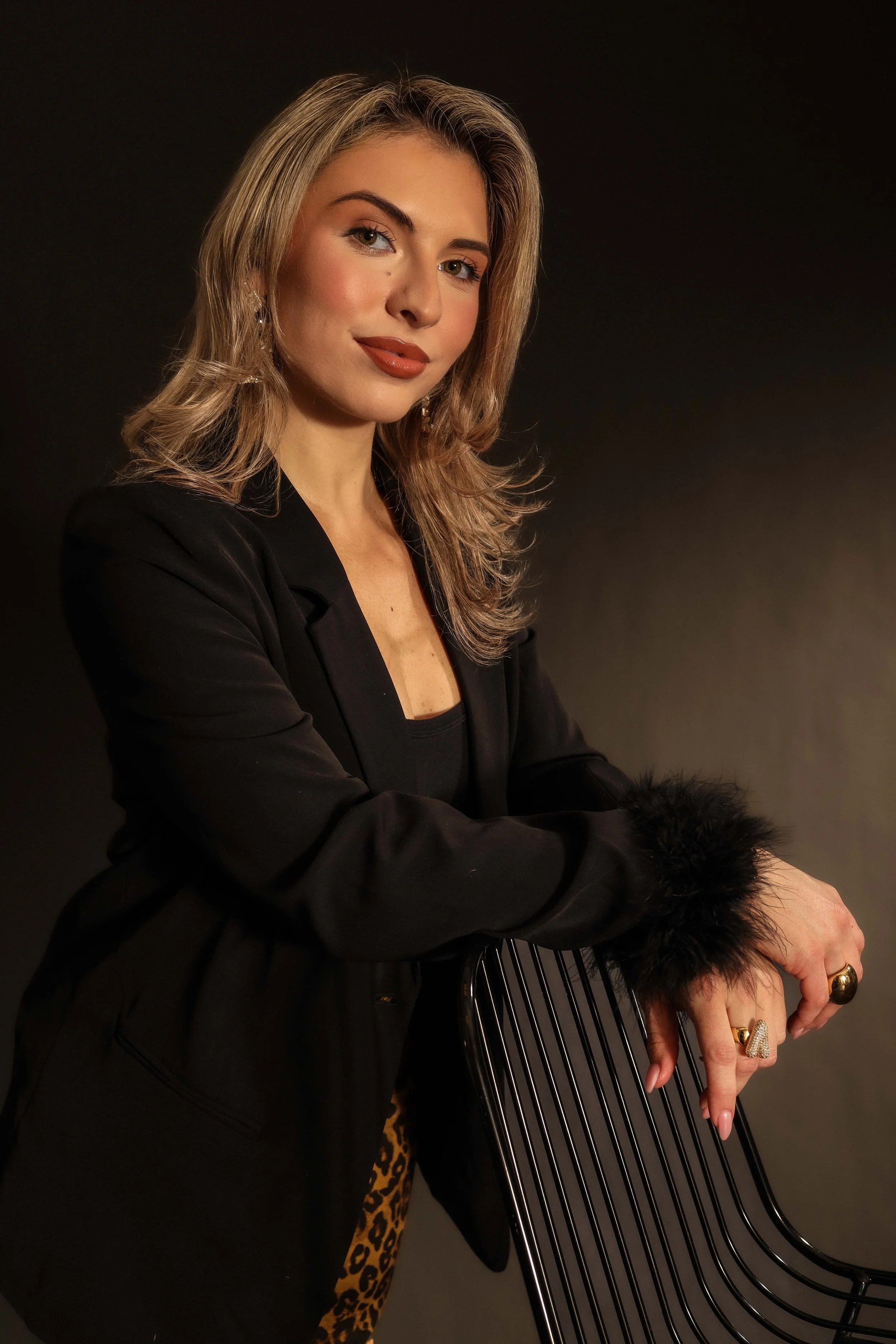 Valerie High Fashion - leaning on chair with both hands.jpg