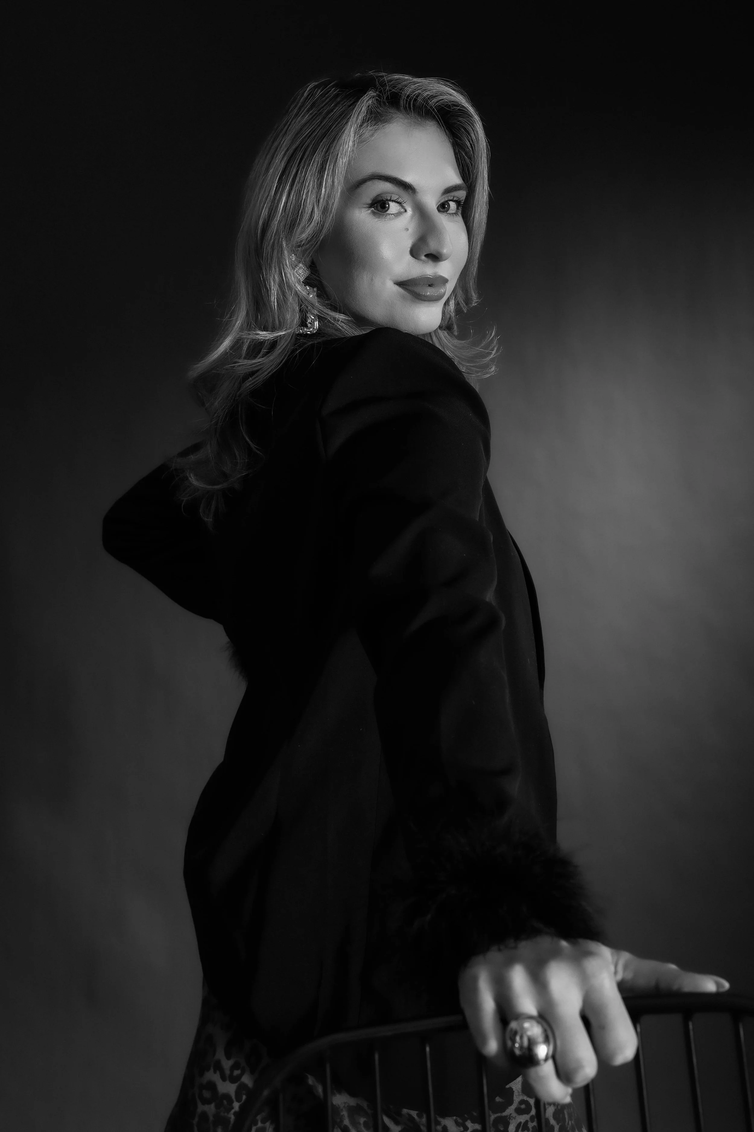Valerie High Fashion - BW looking back on chair one arm.jpg