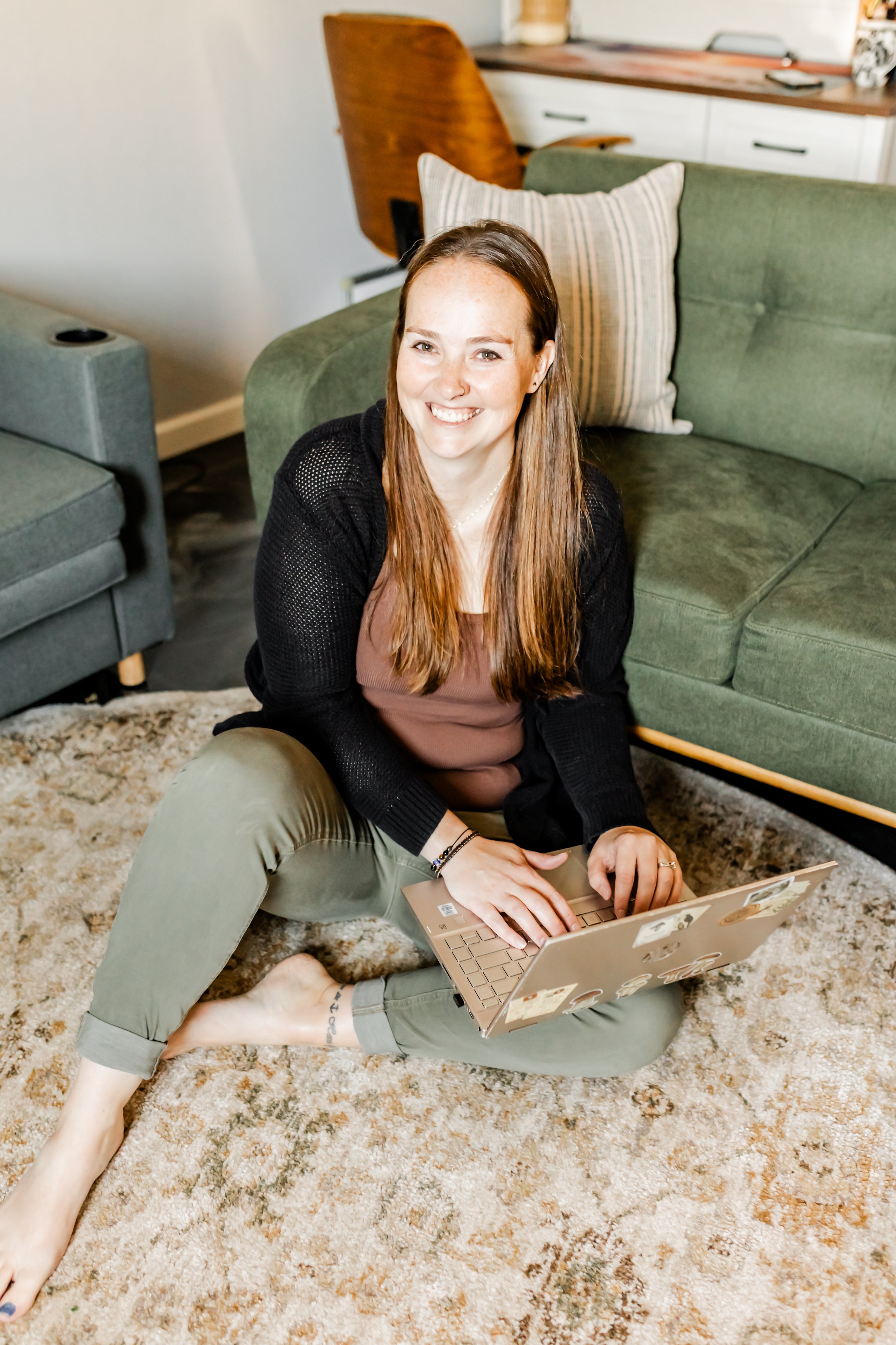 Katie Tyrrell seated in her office, working on a laptop.