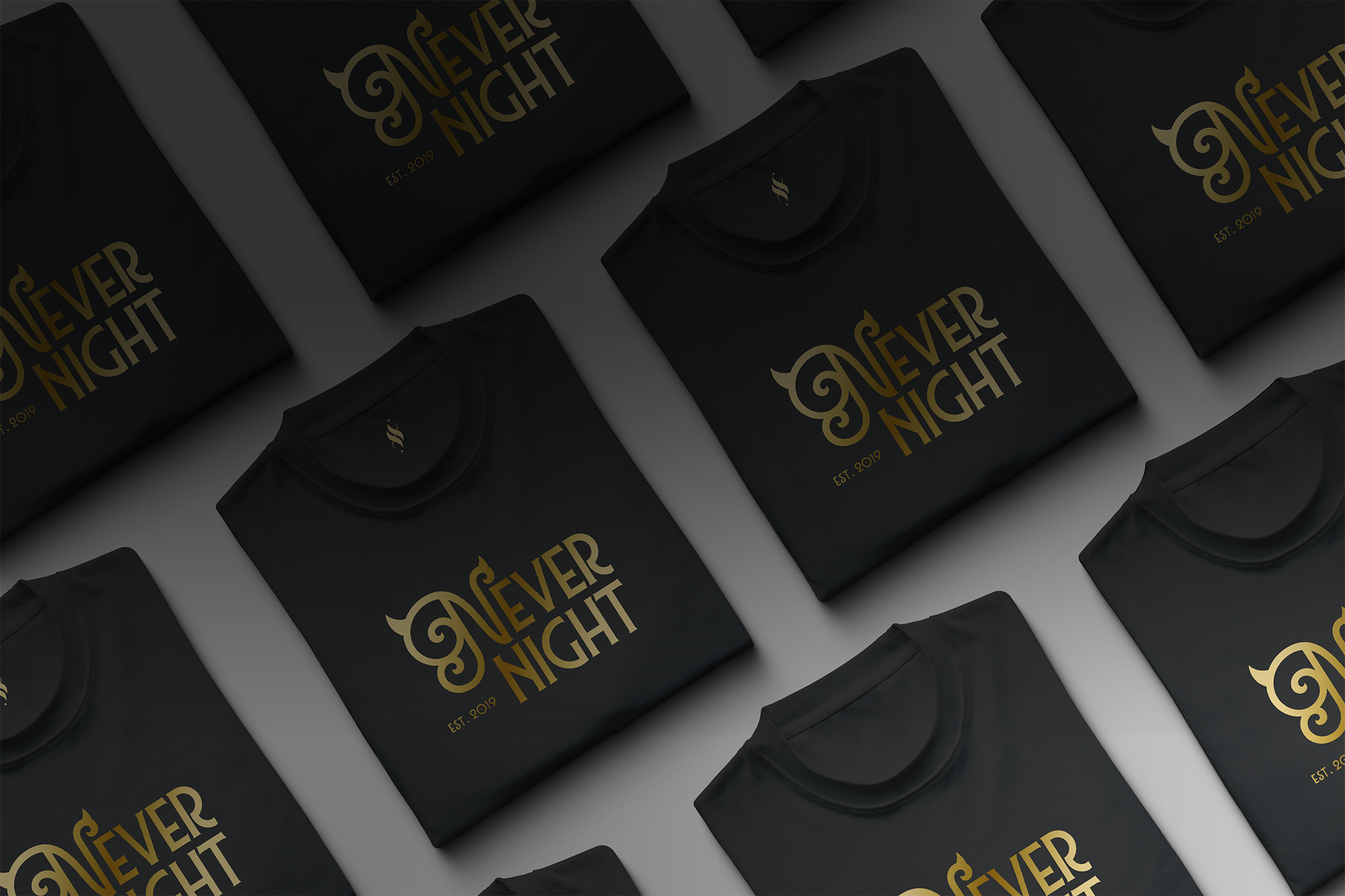 Multiple black boxes with gold text that says 'Never Night' and 'Est. 2019'.