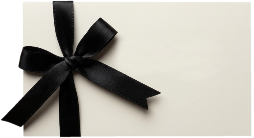 White gift box wrapped with a black ribbon tied in a bow.