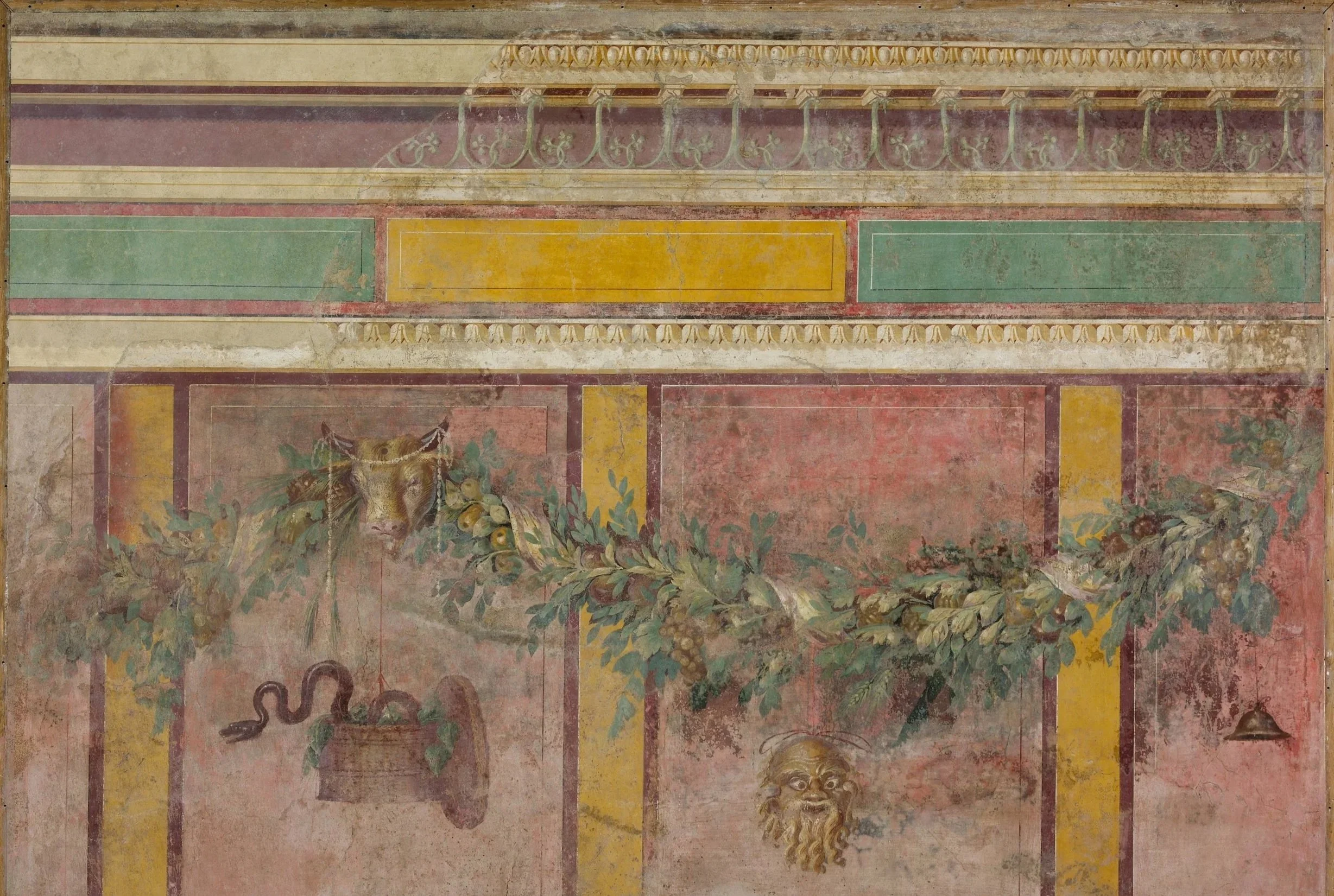 Fresco wall painting featuring colorful panels and decorative motifs, with visible part of a mythical creature or lion head at the bottom.