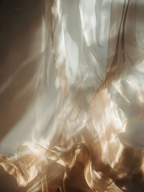 Close-up of fabric draped and illuminated to showcase its soft, flowing texture and shiny surface.