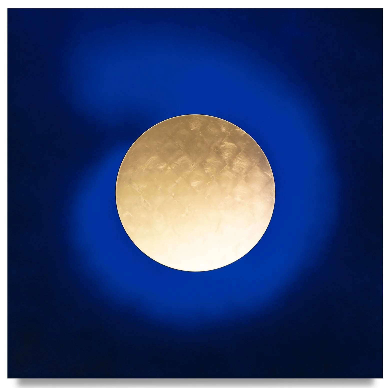 Large bright moon against a dark blue night sky.
