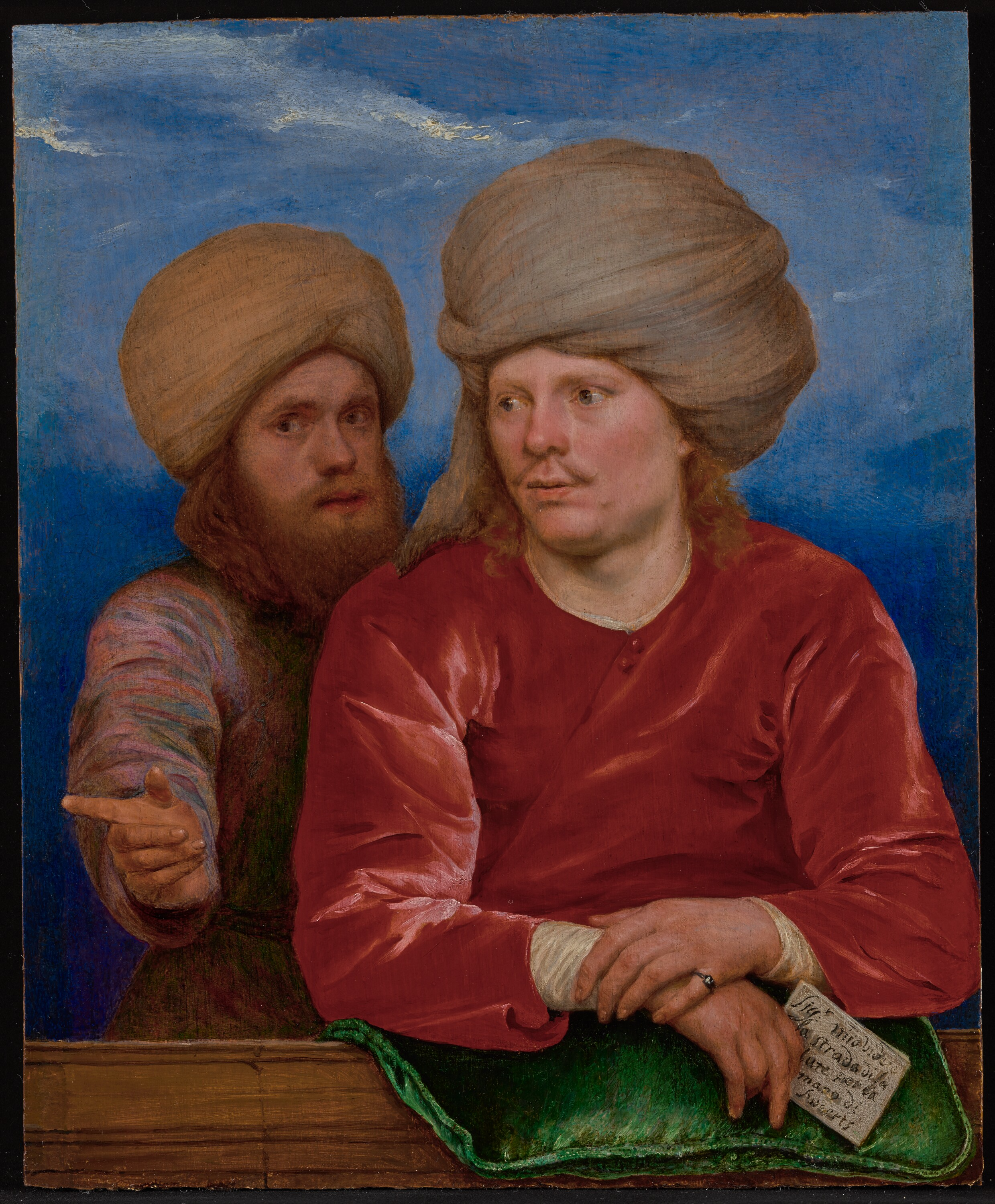Painting of two men with large turbans, one with long hair and a red shirt, the other with a beard and a multicolored shirt, against a blue sky background.