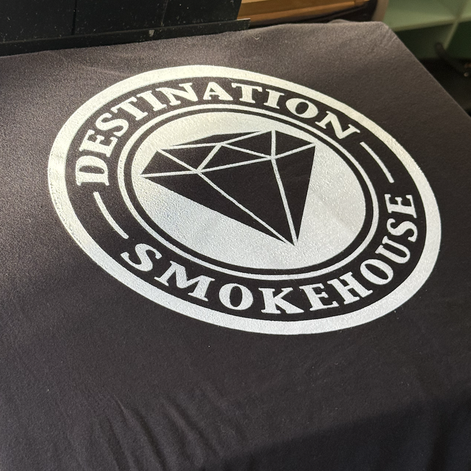 Logo with a diamond symbol and the text 'Destination Smokehouse' in a circular design.