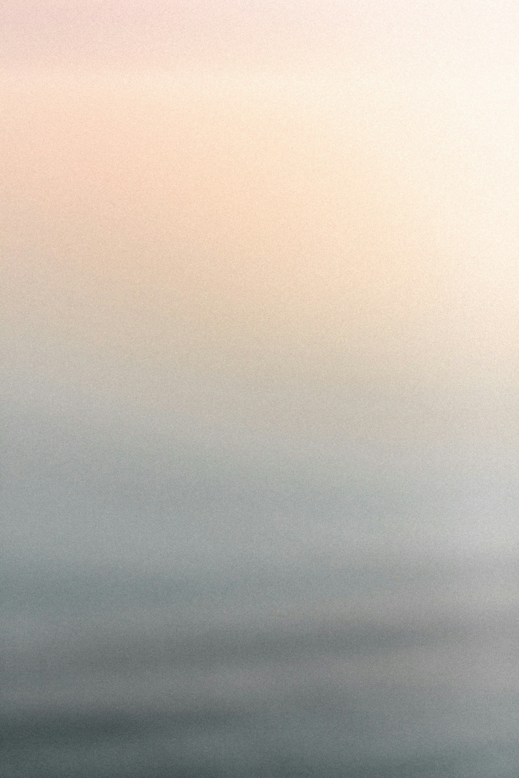 A background picture with an almost grainy texture. The photo transitions from a bright orange to an almost blue color, similar to a sunset.