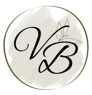 A circular logo with a gray and white watercolor background, featuring black cursive initials 'V' and 'B' with a stylized leaf design.