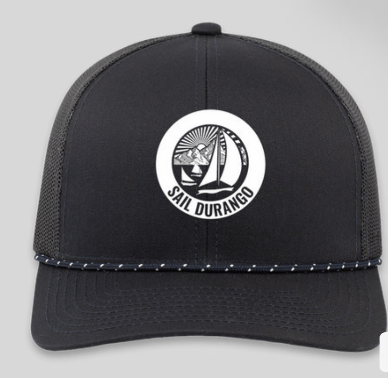 Black and gray trucker cap with a circular white patch featuring a sailboat, mountains, and the text 'Sail Durango'.