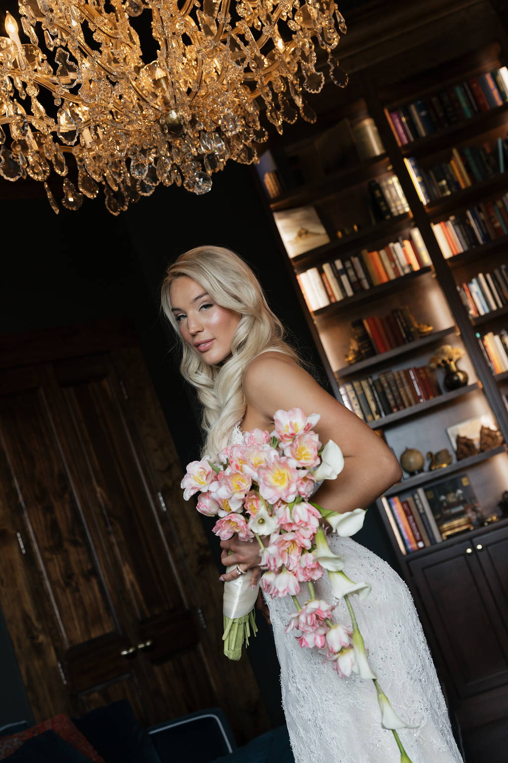 A bride holding a cascading bouquet of tulips.