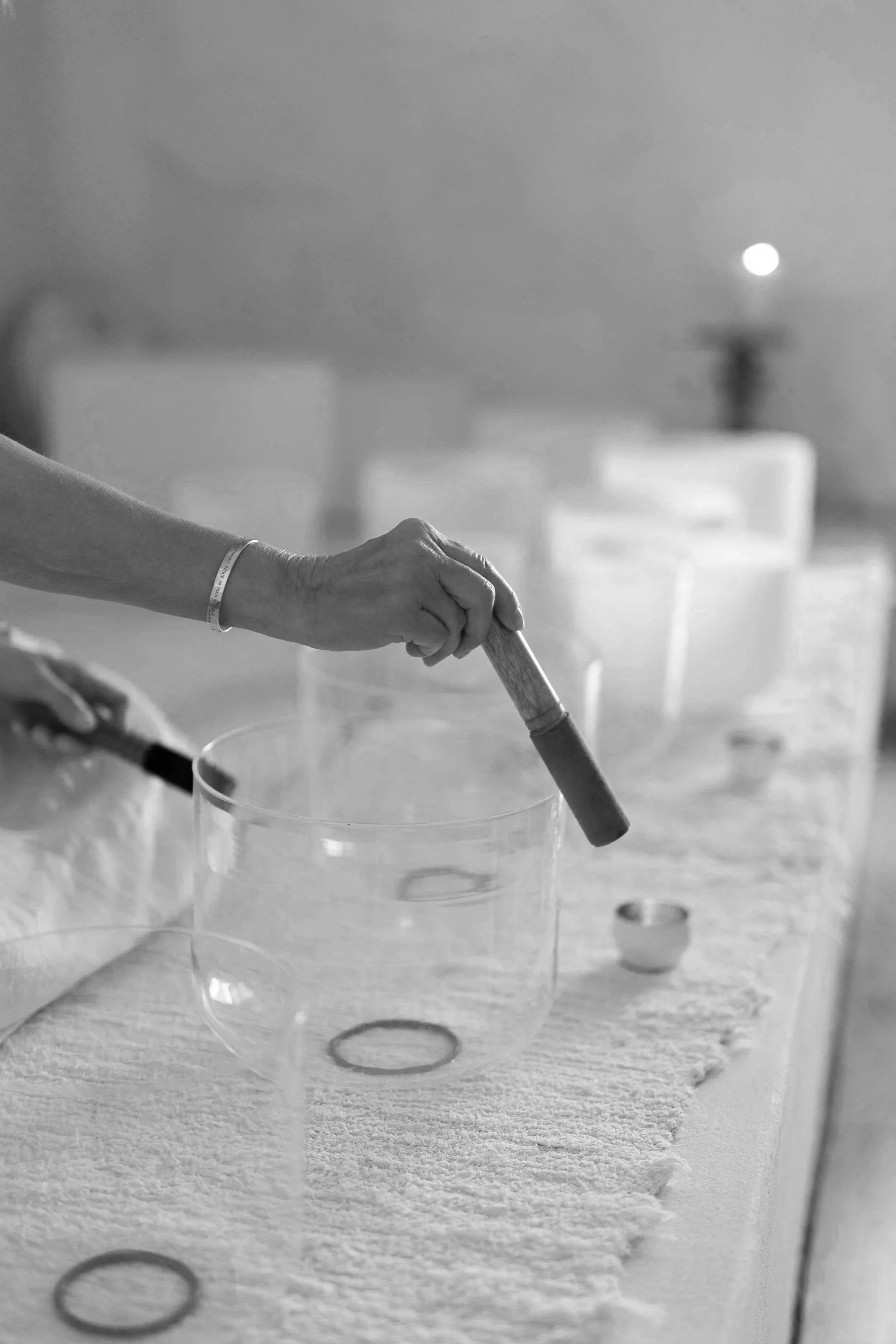 A person pushing a silicone mold with rings on a textured surface, with a moon visible in the night sky.