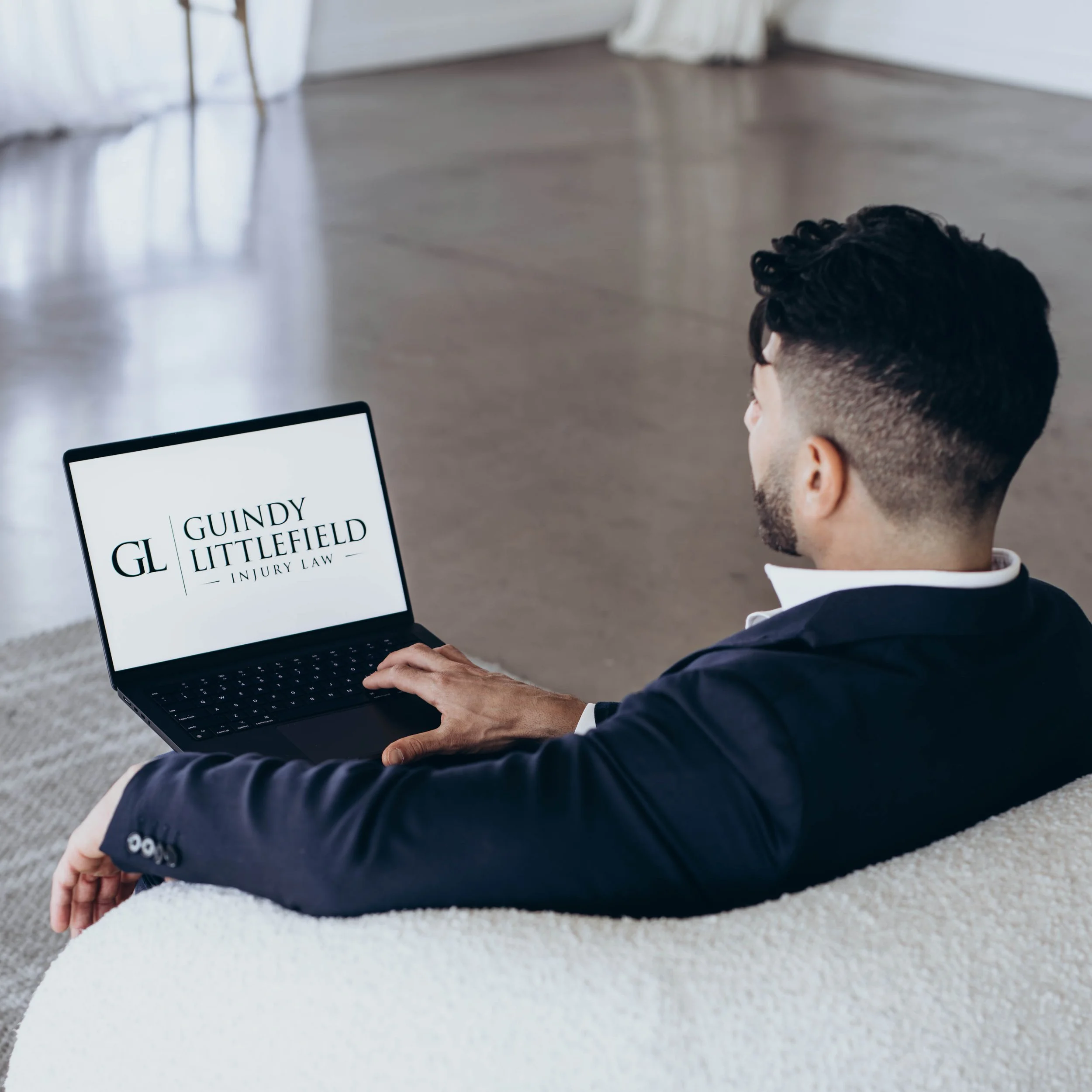 Guindy Littlefield Injury Law lawyer reviewing case on laptop, Las Vegas personal injury lawyer consultation