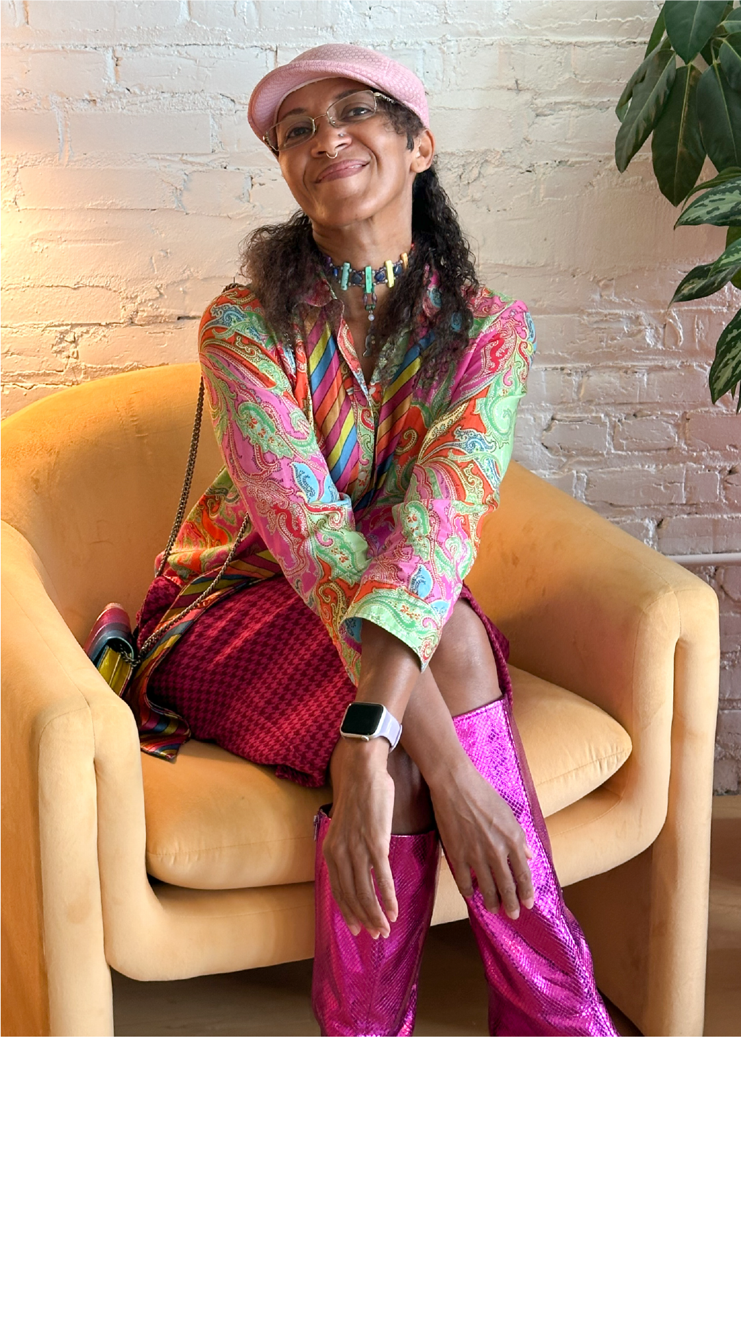 Image of Havalynn seated in a yellow chair for a professional headshot.