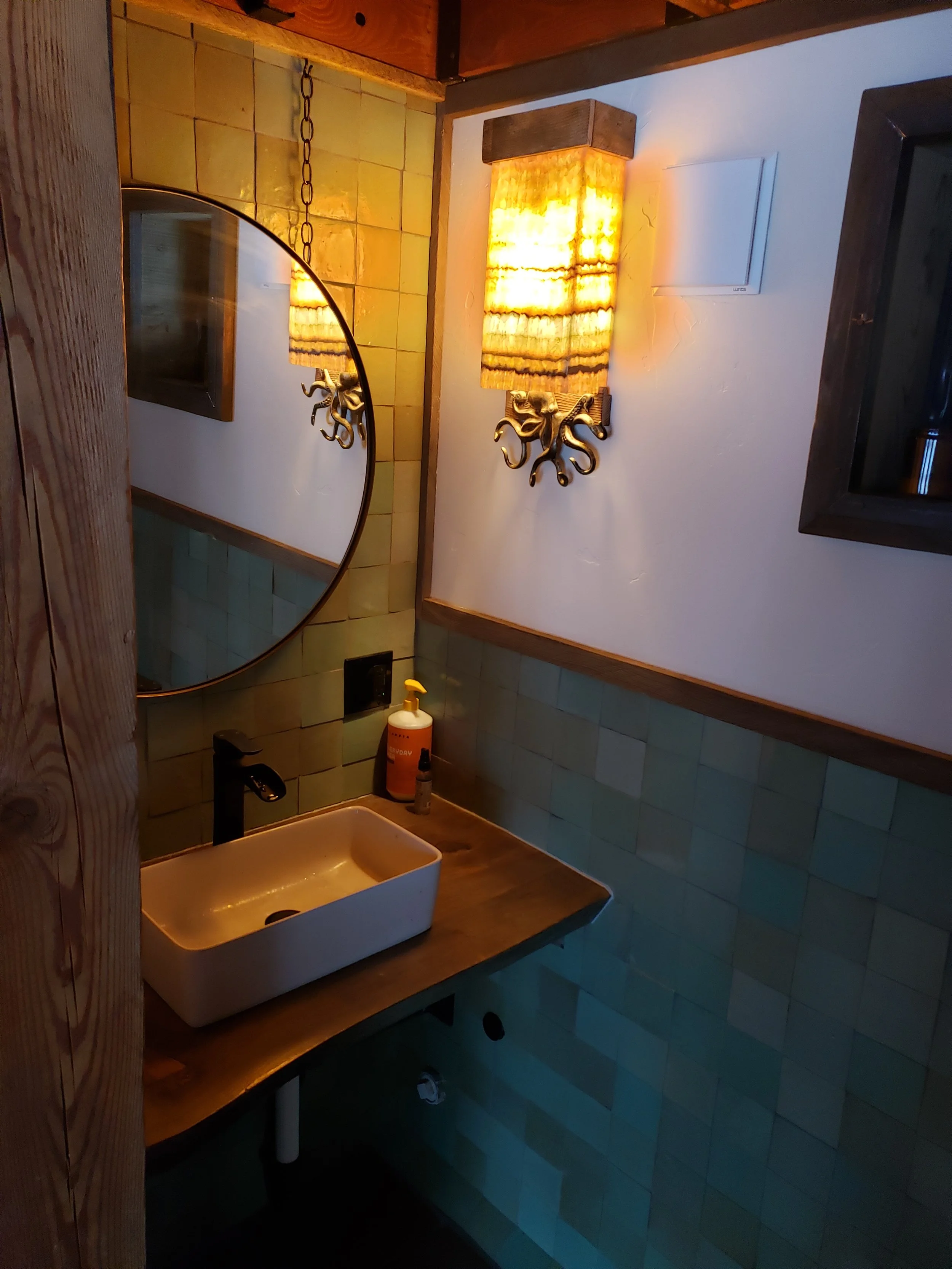 Lodge bathroom has two rooms. This is the toilet room with a sink.