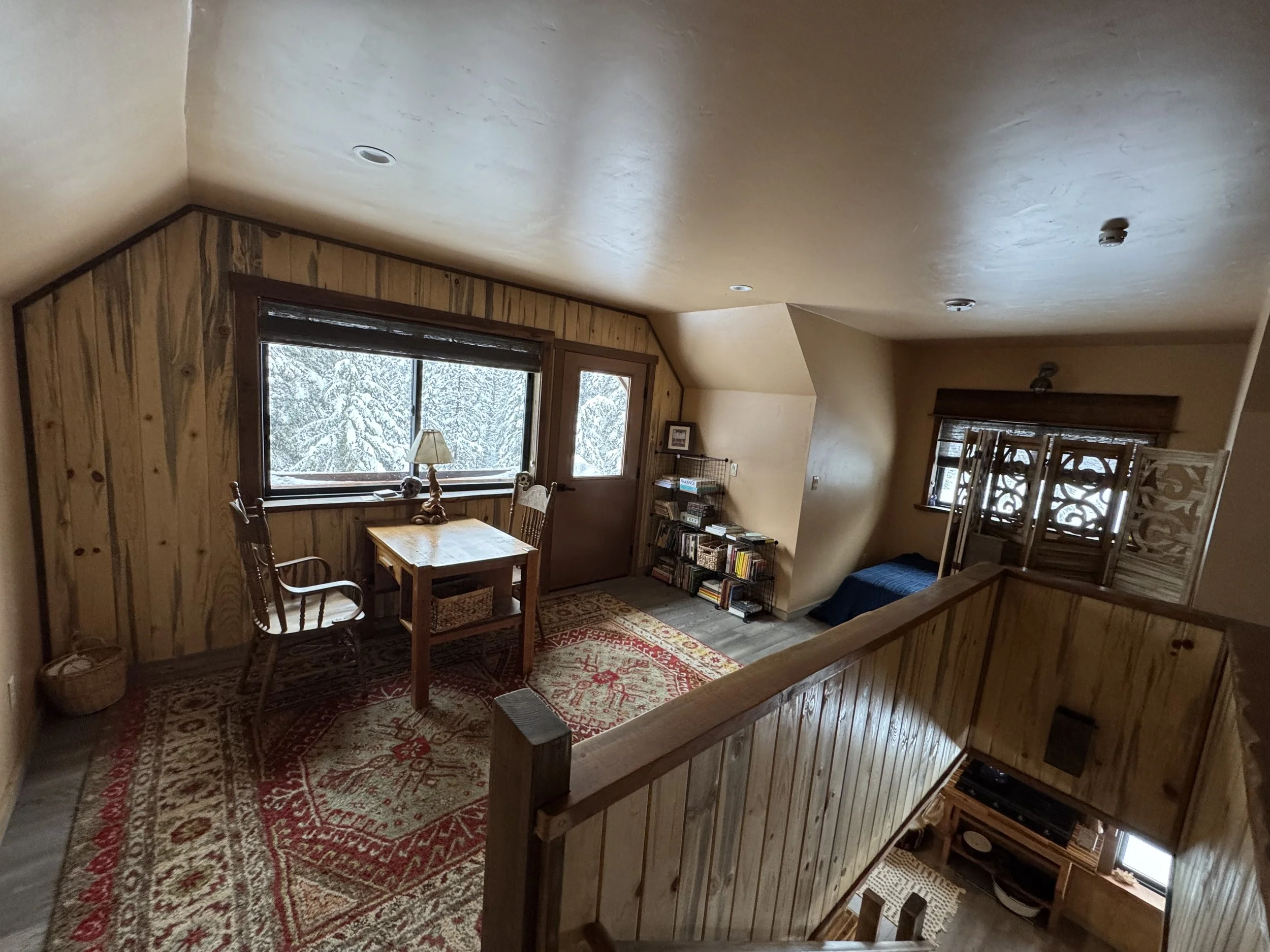 There is a common room upstairs in the Barn with a desk, library and balcony off the back.