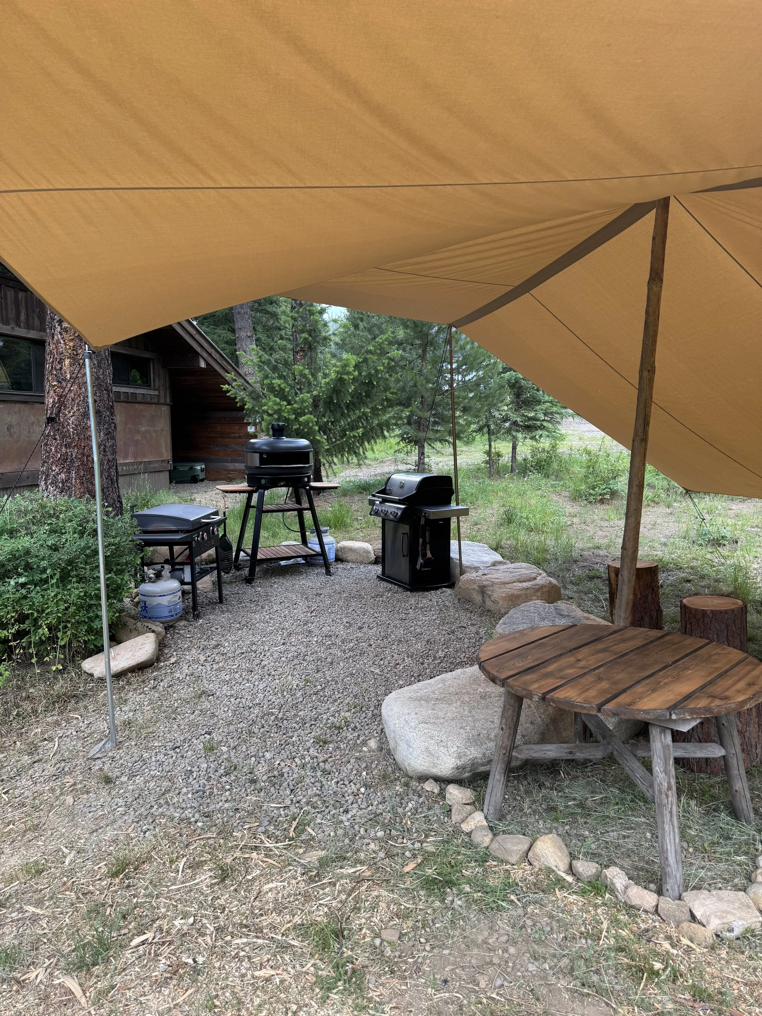 Outdoor kitchen with Weber BBQ, Blackstone Grill and large Gozney pizza oven.