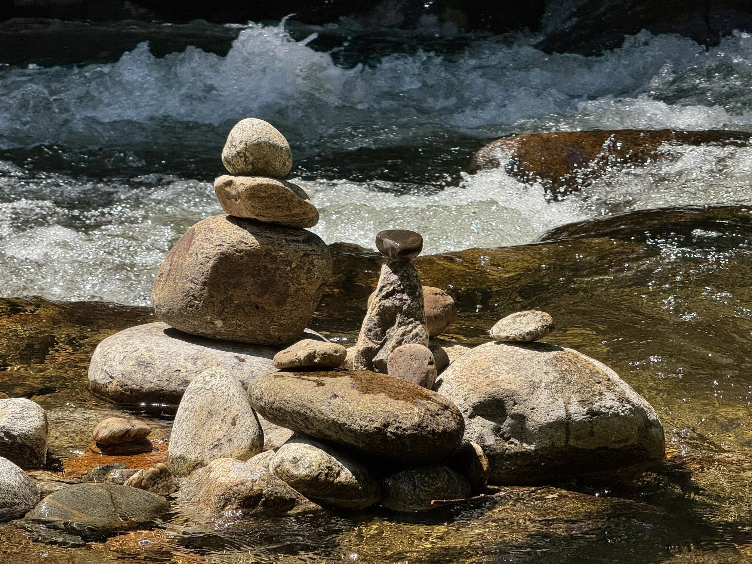 Geometric rock stacks in river.
