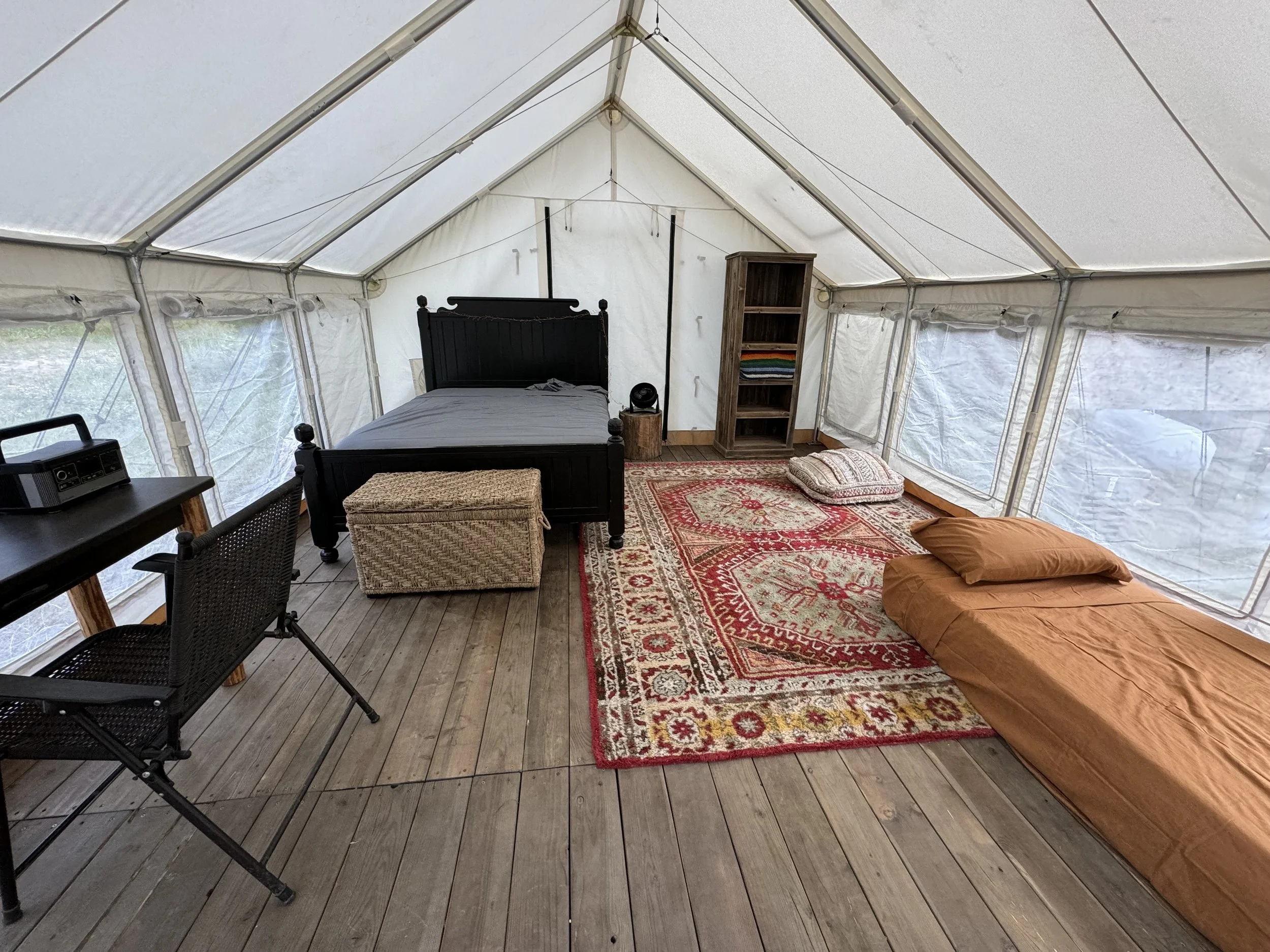 Wall tent is well furnished like your room outside.