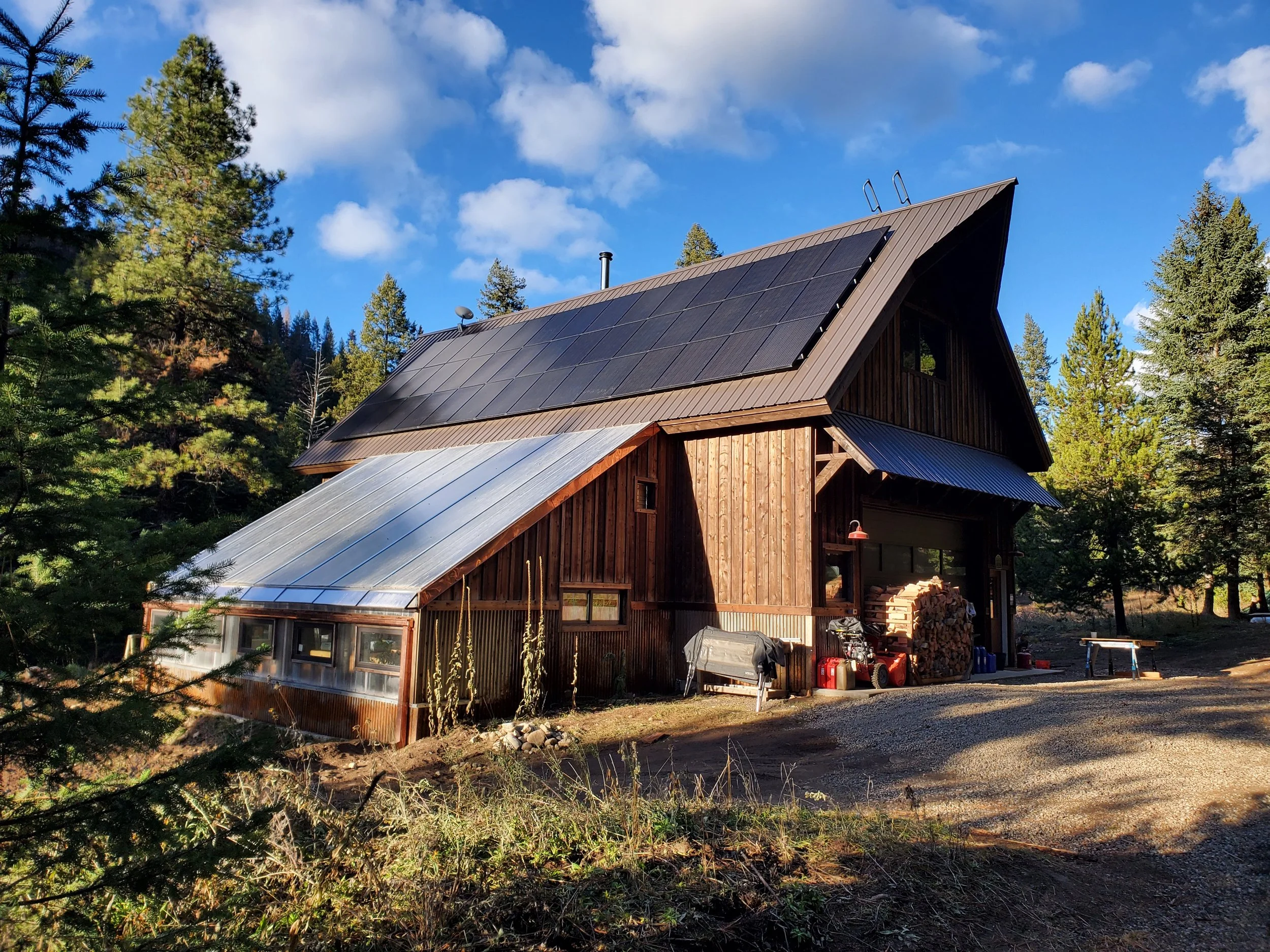 The Barn has a large Greenhouse attached to it and a natural pond outside. Solar panels can be seen which is the source of our power.