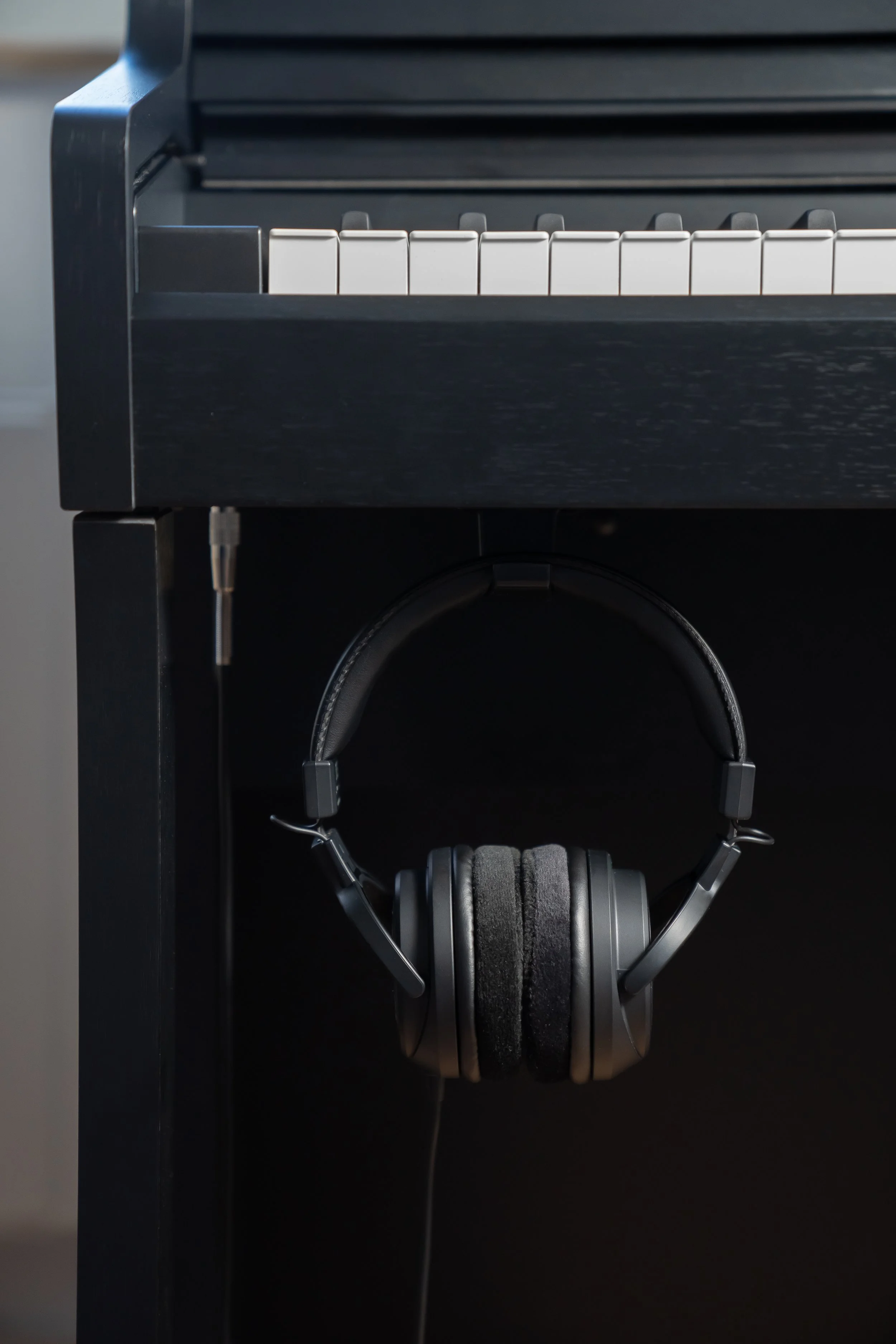 KAWAI CA401 keys and headphones shown hanging