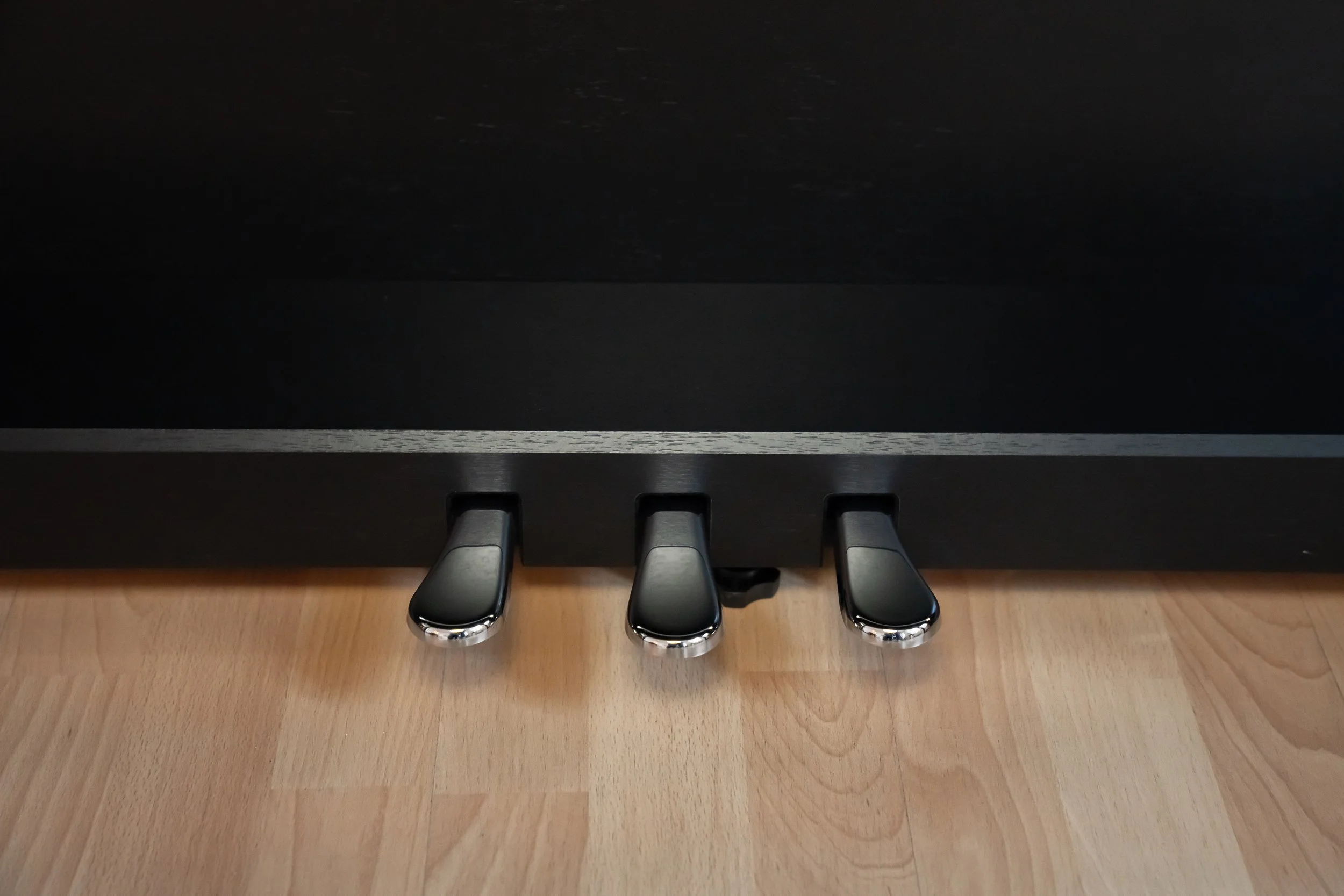KAWAI CA401 Glossy pedals with wooden floor background 
