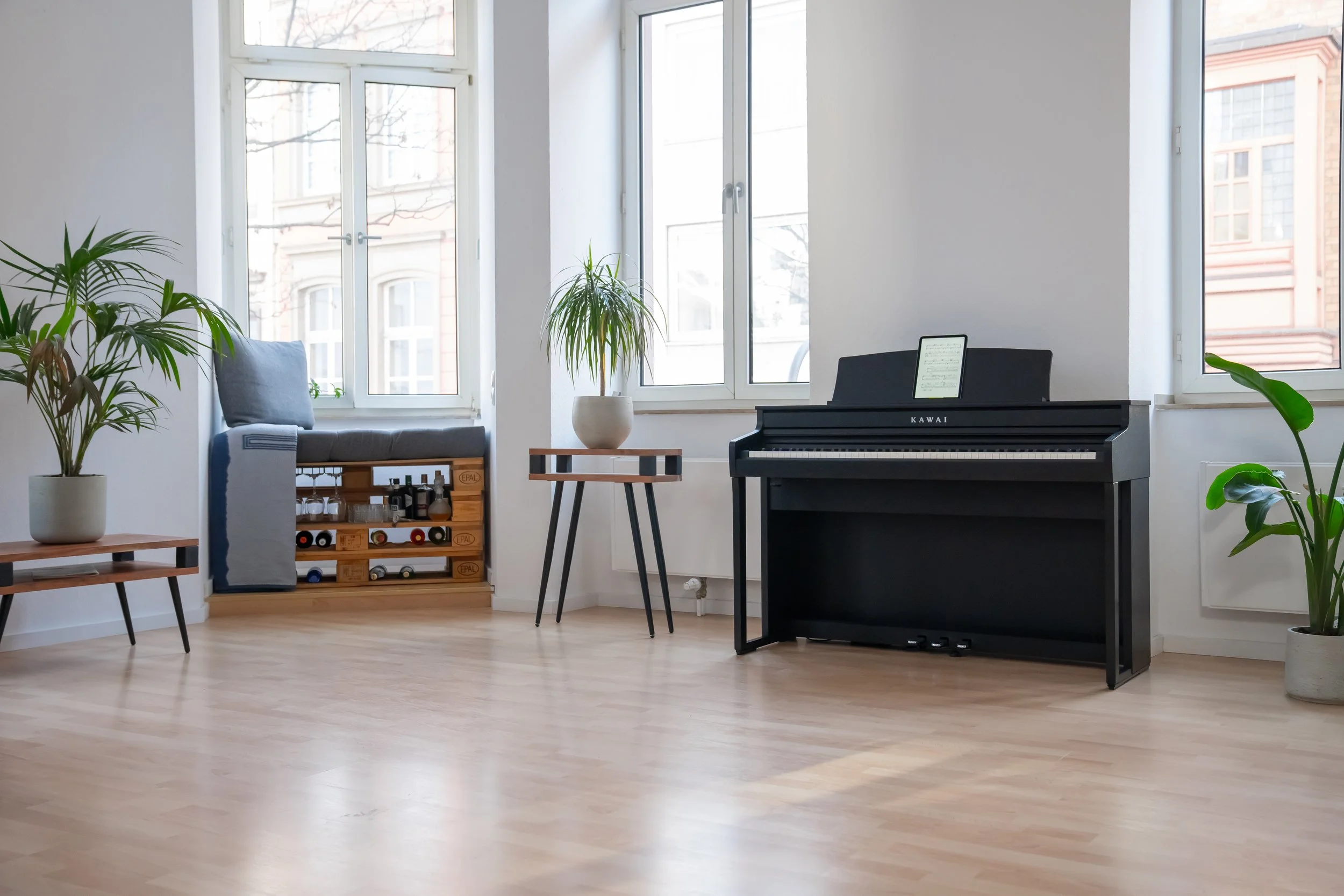 KAWAI CA401 shown in white room with wood floors and plants. 