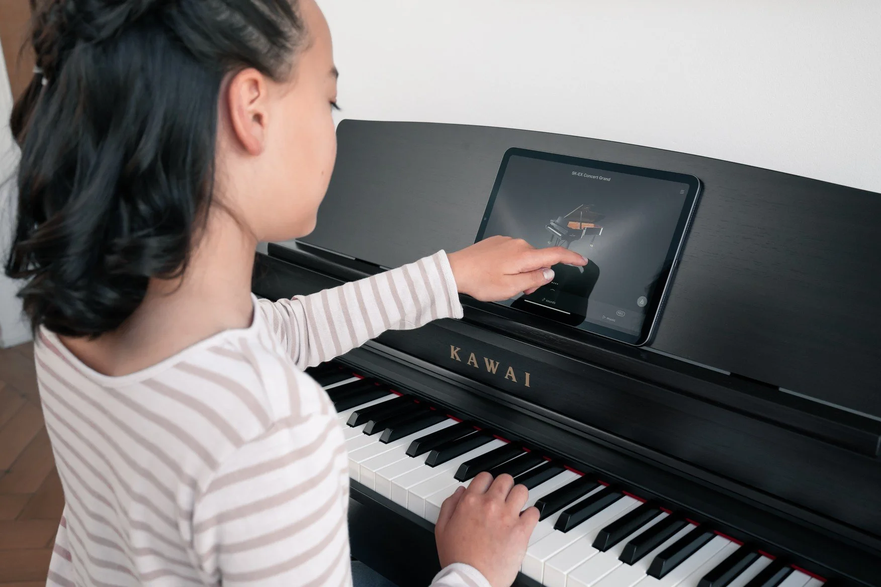 KAWAI CN301 with Kawai program on iPad resting on music desk
