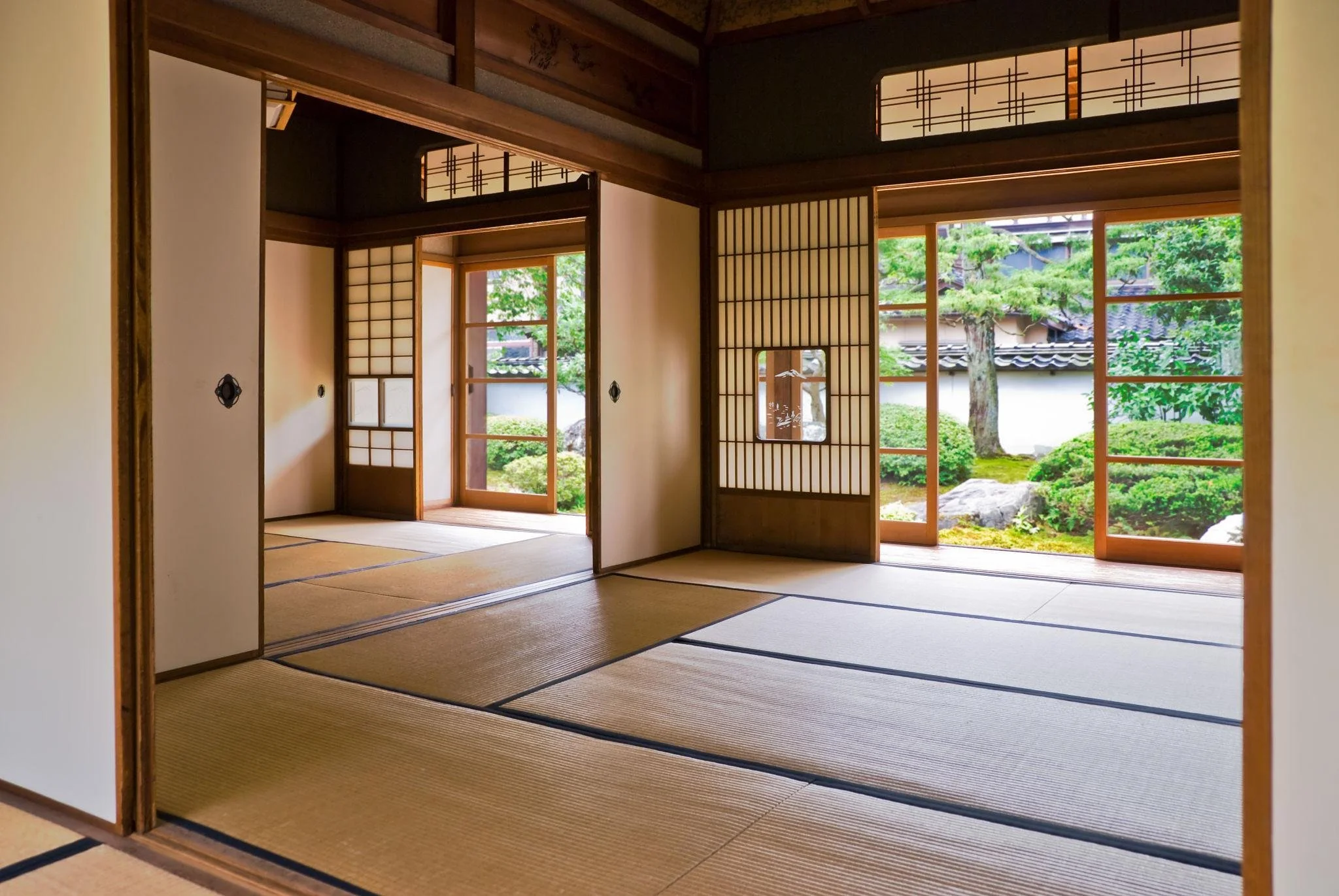 Old Style Japanese Living Space with Paper walls, bamboo floor matts and garden outside of window