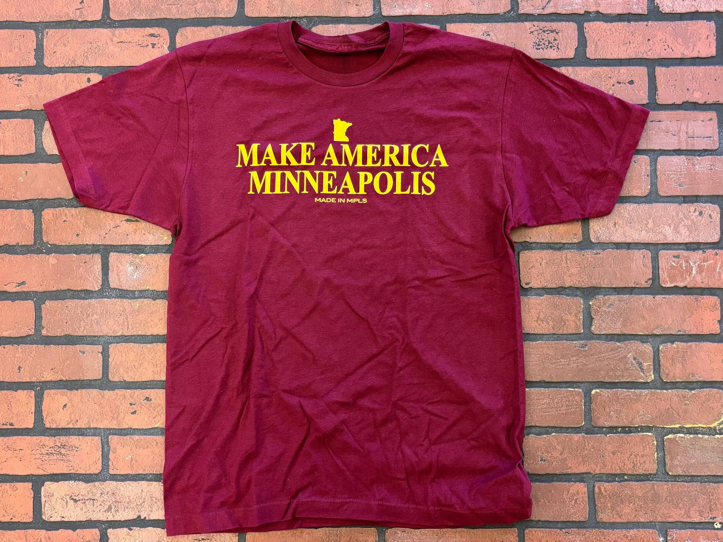 Maroon Unisex T-shirt that says "Make America Minneapolis" in gold print