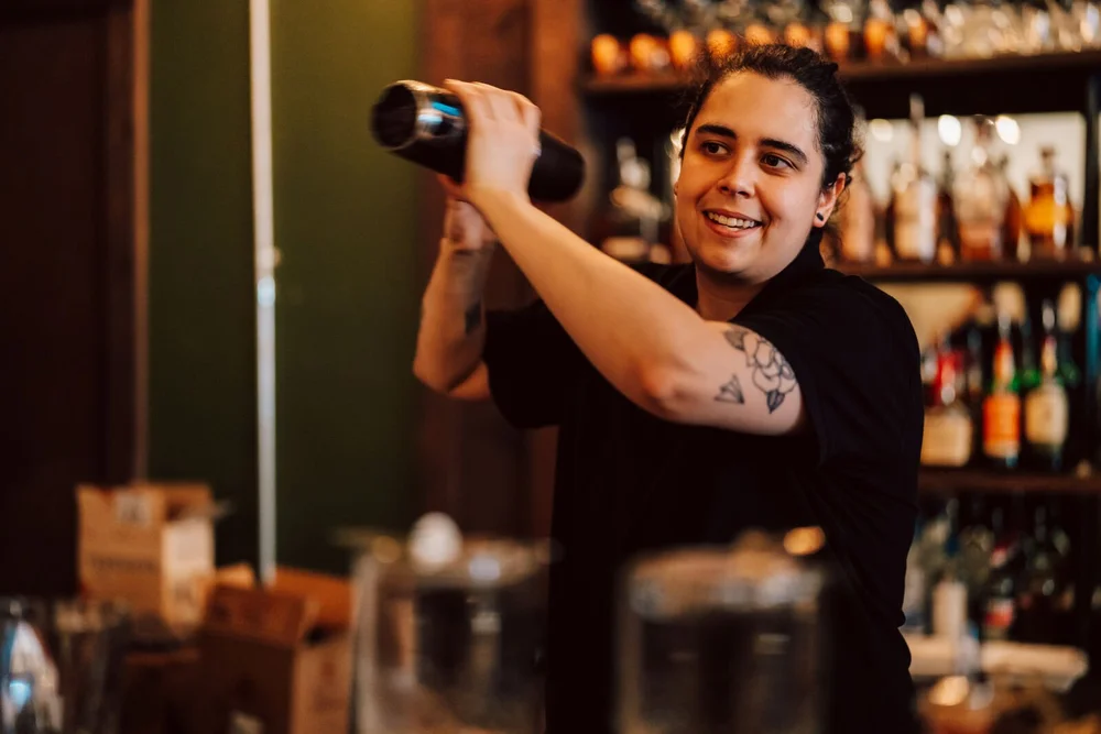 A bartender pouring a cocktail at The 1879