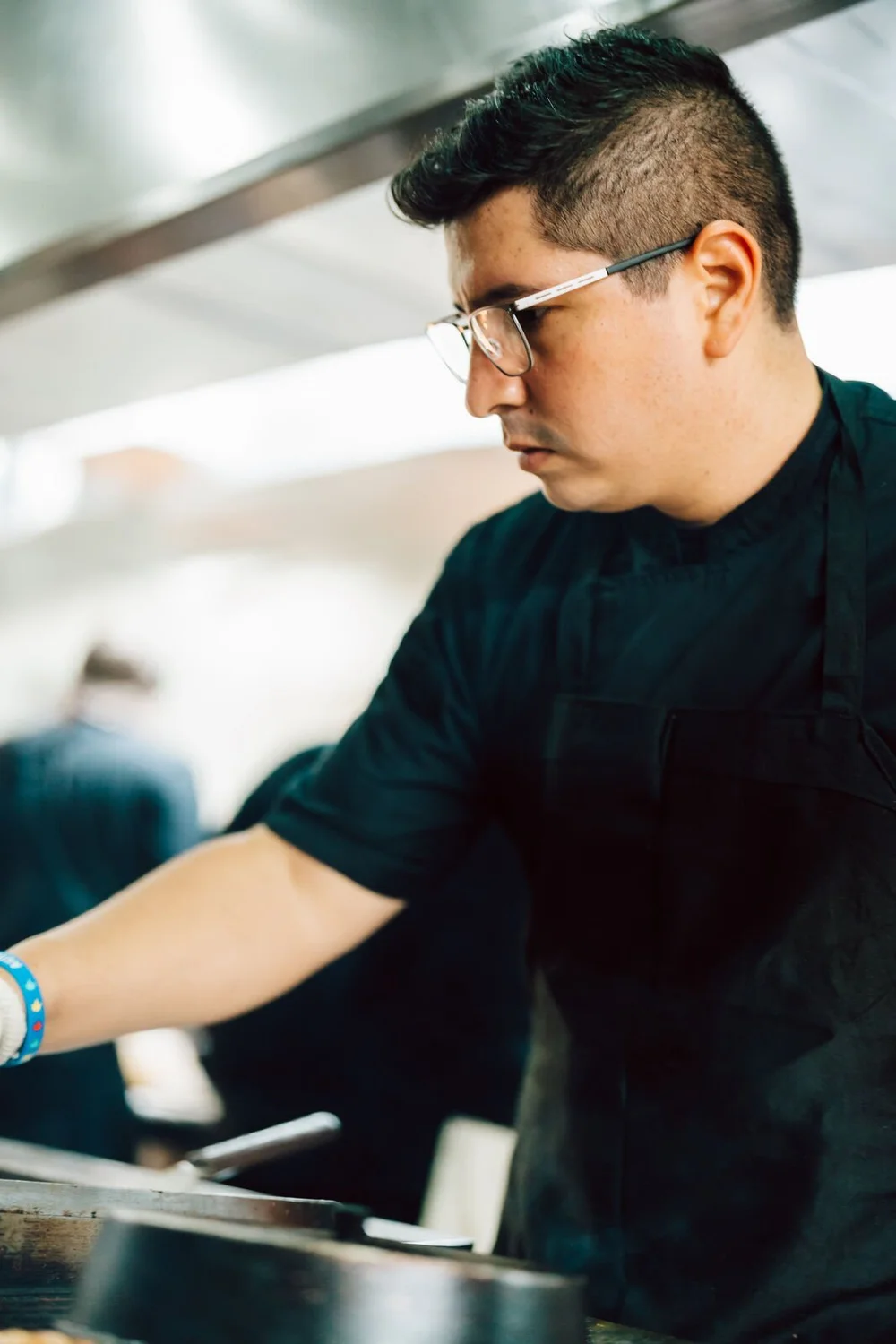 A chef cooking on the line at The 1879