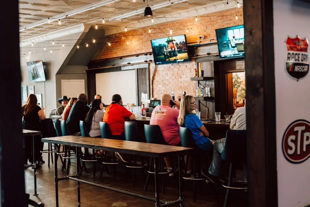 Guests at the pub bar watching the game at The 1879