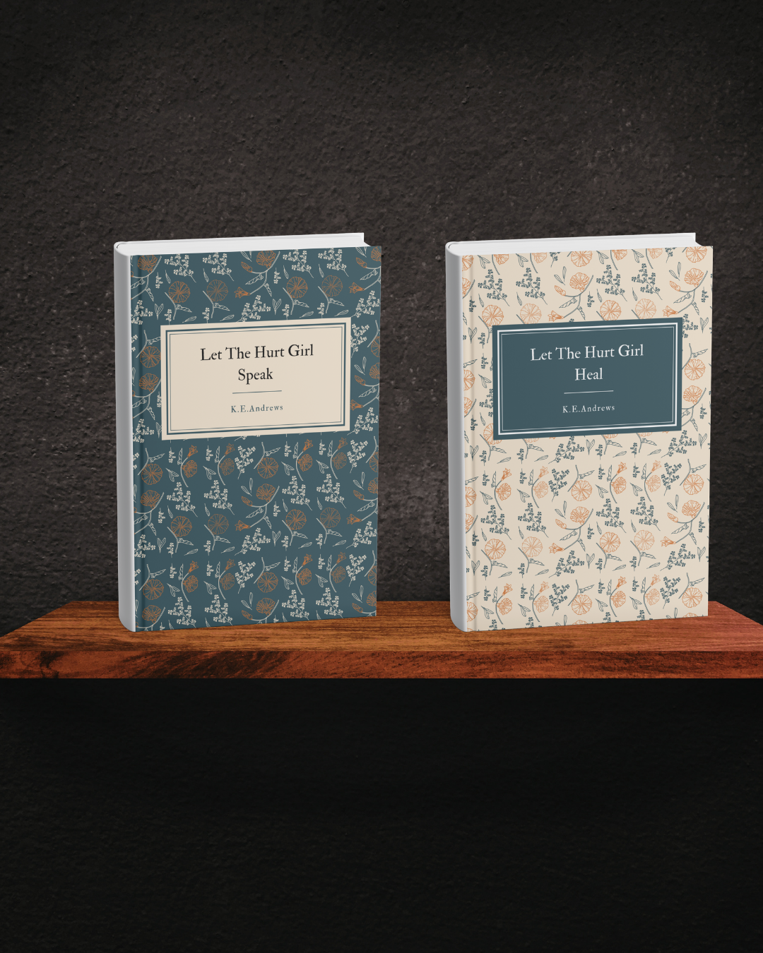 Two books by K.E. Andrews displayed on a wooden shelf against a dark wall. The left book reads "Let The Hurt Girl Speak" with a dark blue and floral cover, and the right book reads "Let The Hurt Girl Heal" with a light background and floral cover.