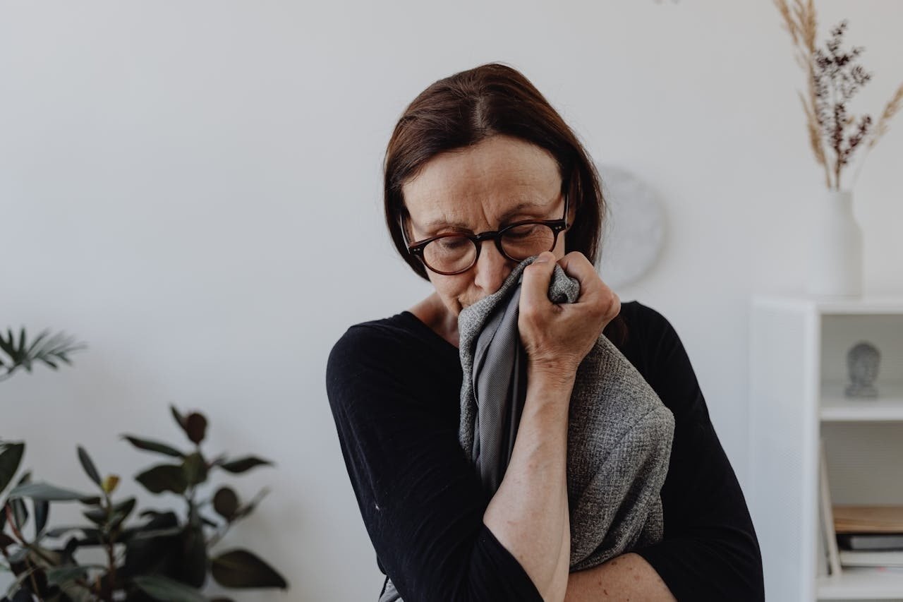 sad woman holding a jacket close to her