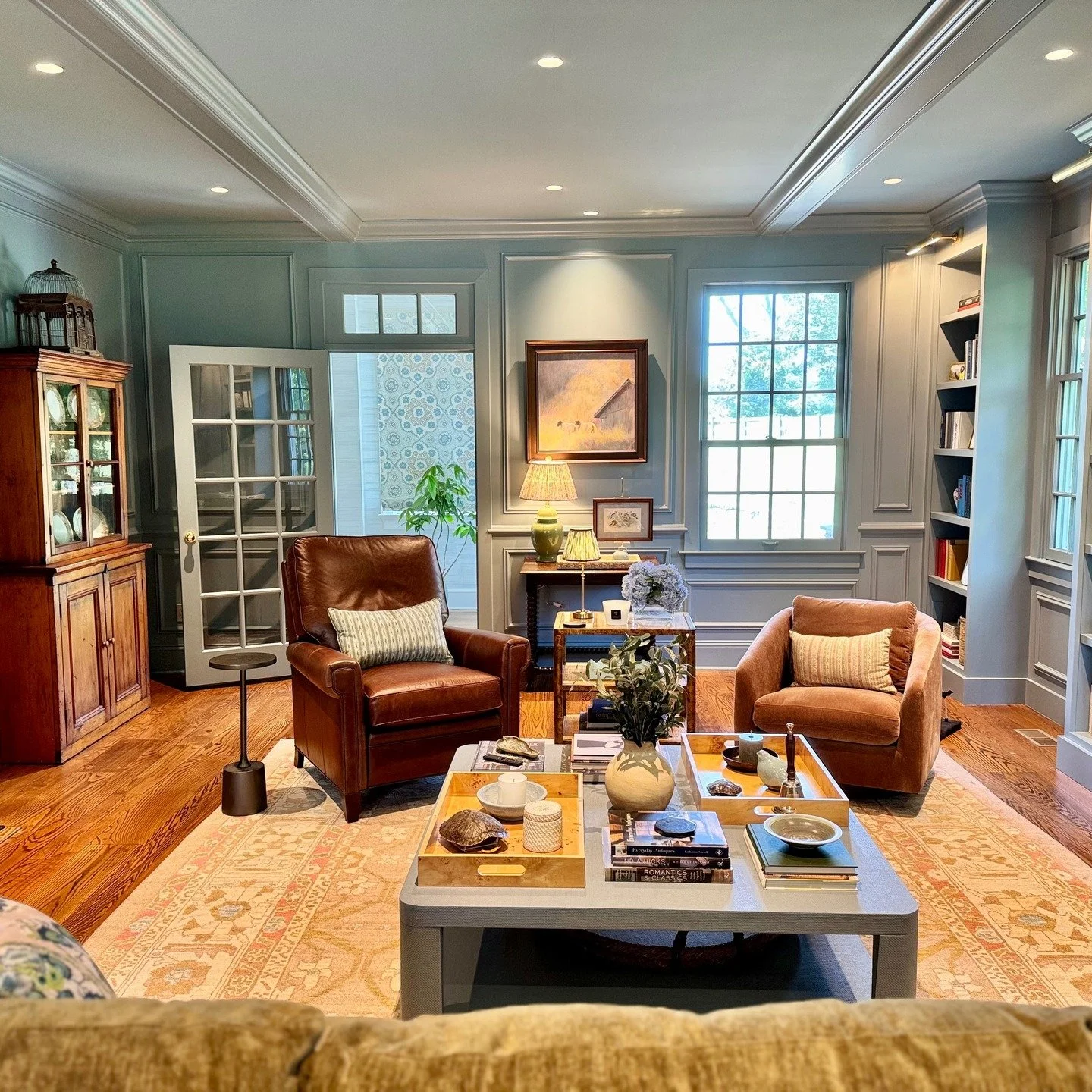 A little before, during and after. Swipe to see the progression of this Connecticut living room that went from cold and dreary to warm and full of charm.