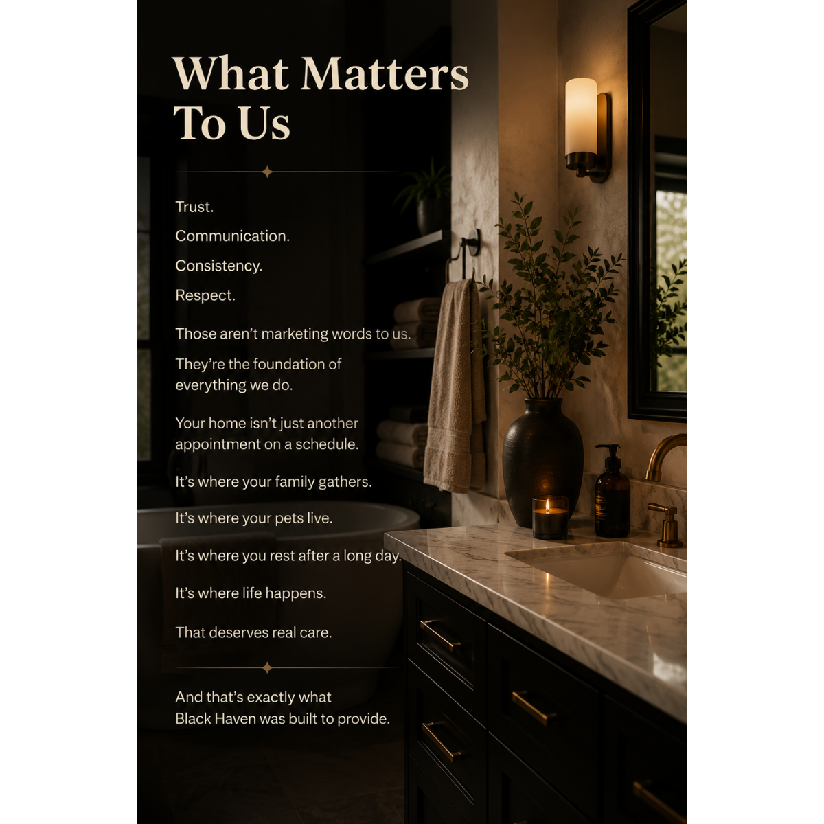 Interior bathroom scene with a black vanity, marble countertop, vase with greenery, lit candle, soap dispenser, towel on shelf, mirror, and warm lighting.