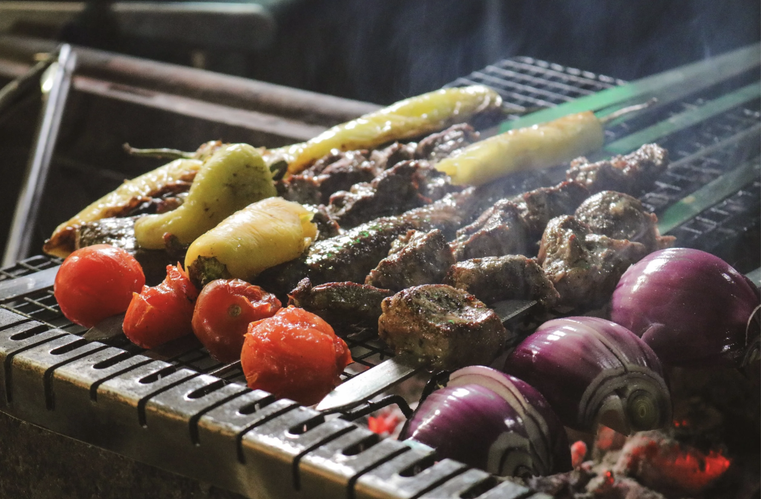 close-up of steak, onion, tomato, and peppers