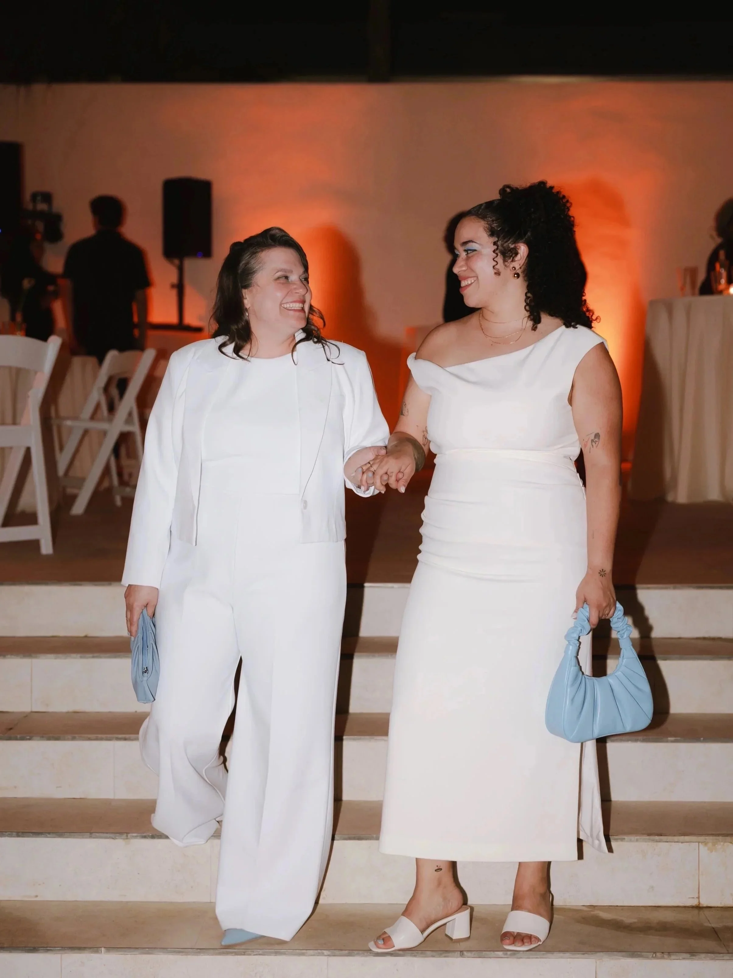 Lesbian Couple on their wedding day, standing hand in hand. 