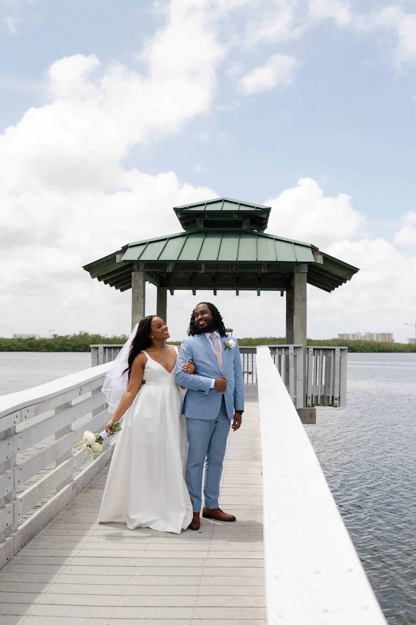Bride and groom standing together, looking at each other