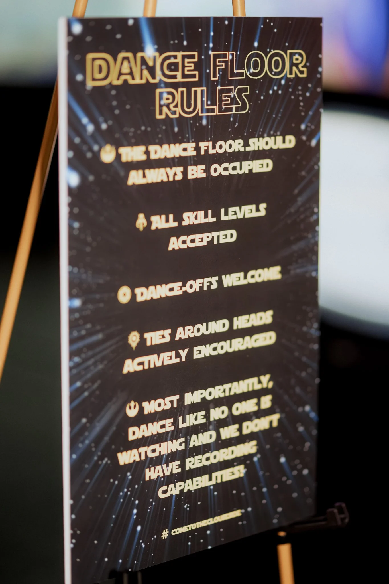 A sign with rules for the dance floor, including guidelines like ensuring the dance floor is always occupied, accepting all skill levels, and welcoming dance-offs.
