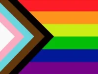 A pride flag with rainbow stripes and a black and brown chevron on the left side.