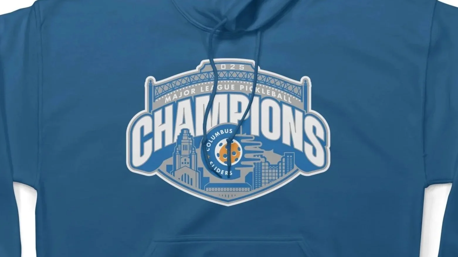 Blue hoodie with a Columbus Clippers Major League Pickleball champions logo featuring a castle, cityscape, and pickleball paddle.