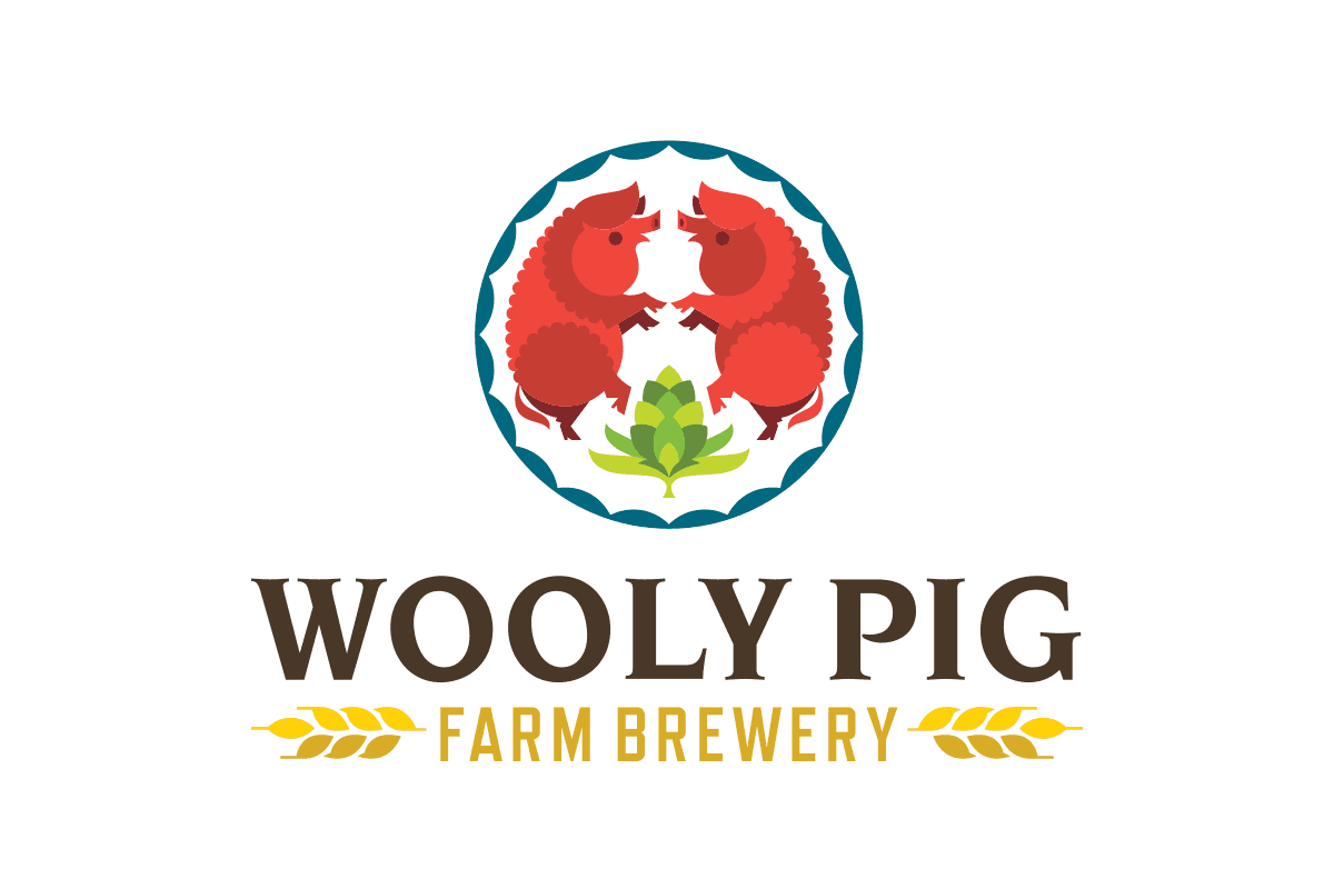 Logo for Wooly Pig Farm Brewery, featuring two red pigs facing each other inside a circular design with green hops at the bottom and decorative blue and white border, along with the brewery's name and two wheat stalks.