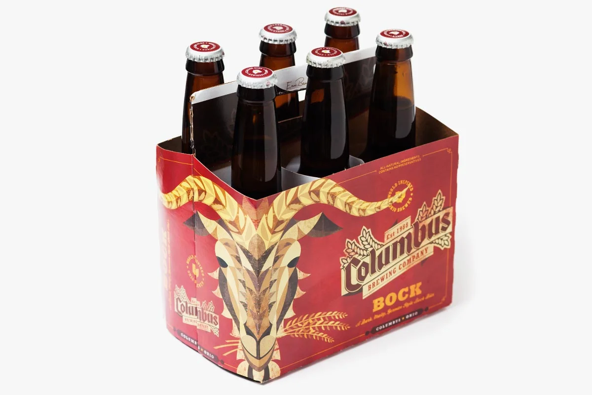 Six bottles of Columbus Brewing Company's Bock beer in a six-pack carrier with a decorative goat skull design.