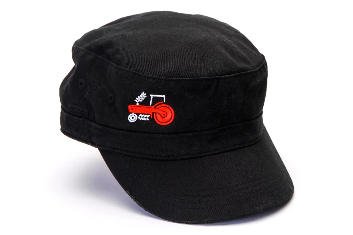 Black military-style cap with a small embroidered logo of a red gun, a target, and white wheat.