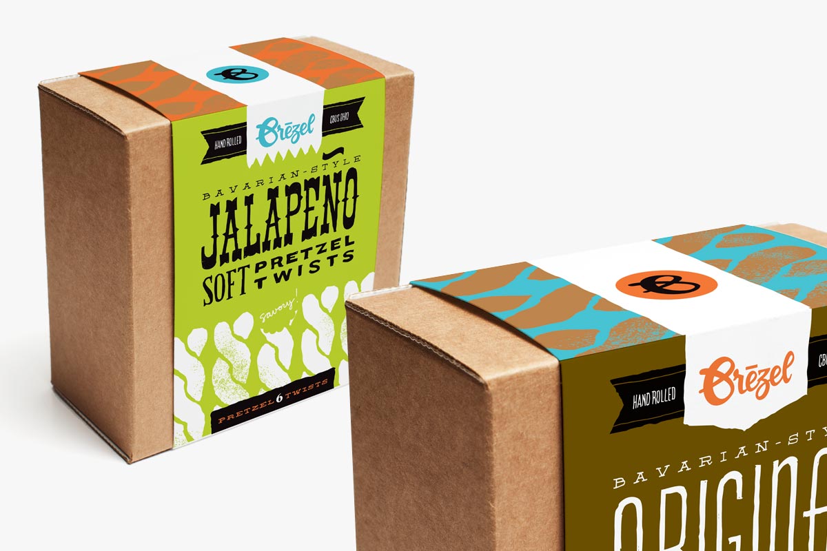 Two cardboard boxes of Örezel Bavarian-style pretzels with colorful packaging designs.