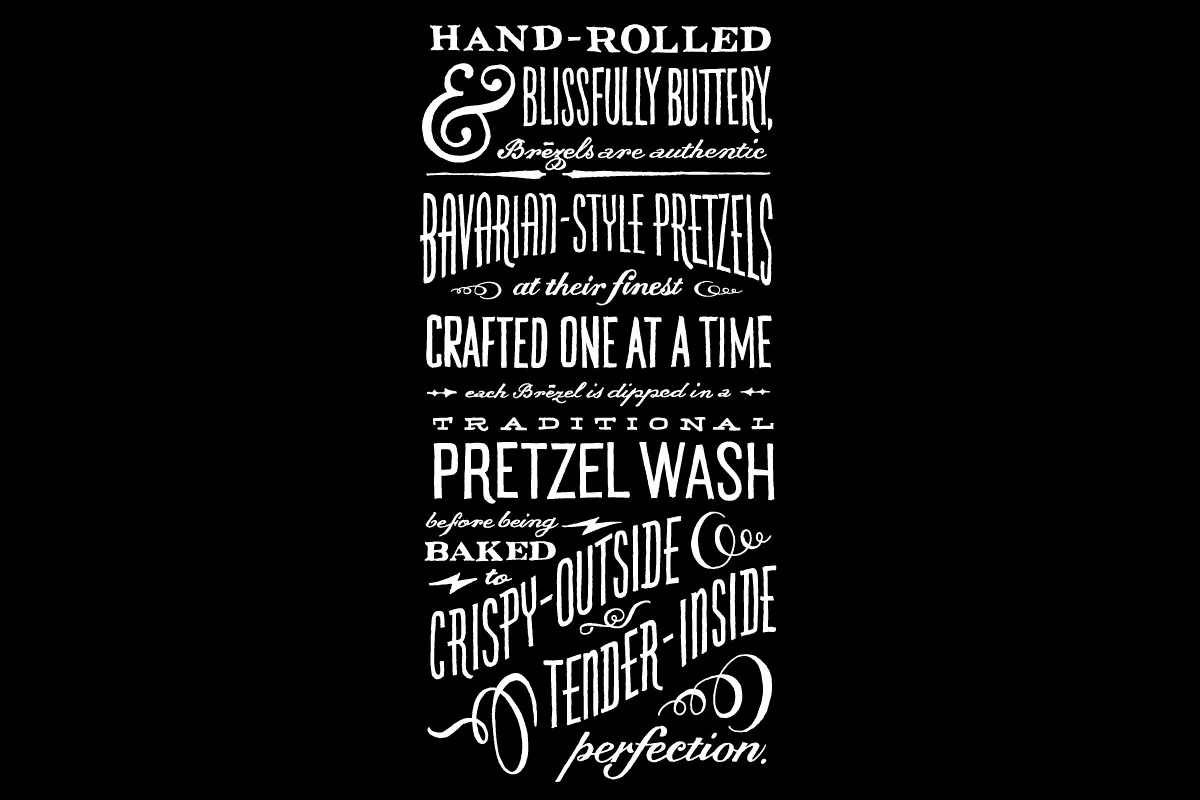 A black background with white decorative text describing Bavarian-style pretzels, including their handcrafted process, traditional pretzel wash, baking, and their crispy outside with tender inside.