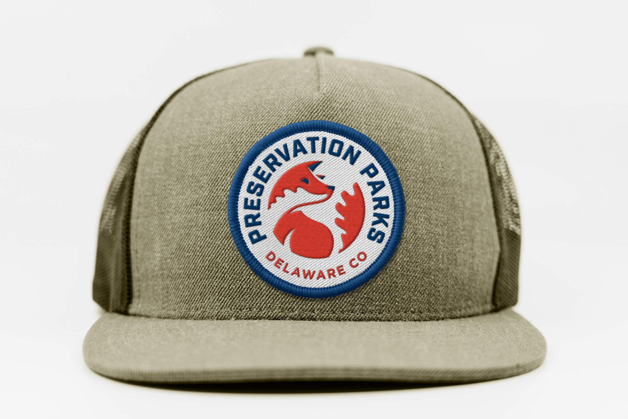 A khaki baseball cap with a circular patch reading "Preservation Parks Delaware Co" featuring a red fox head graphic.